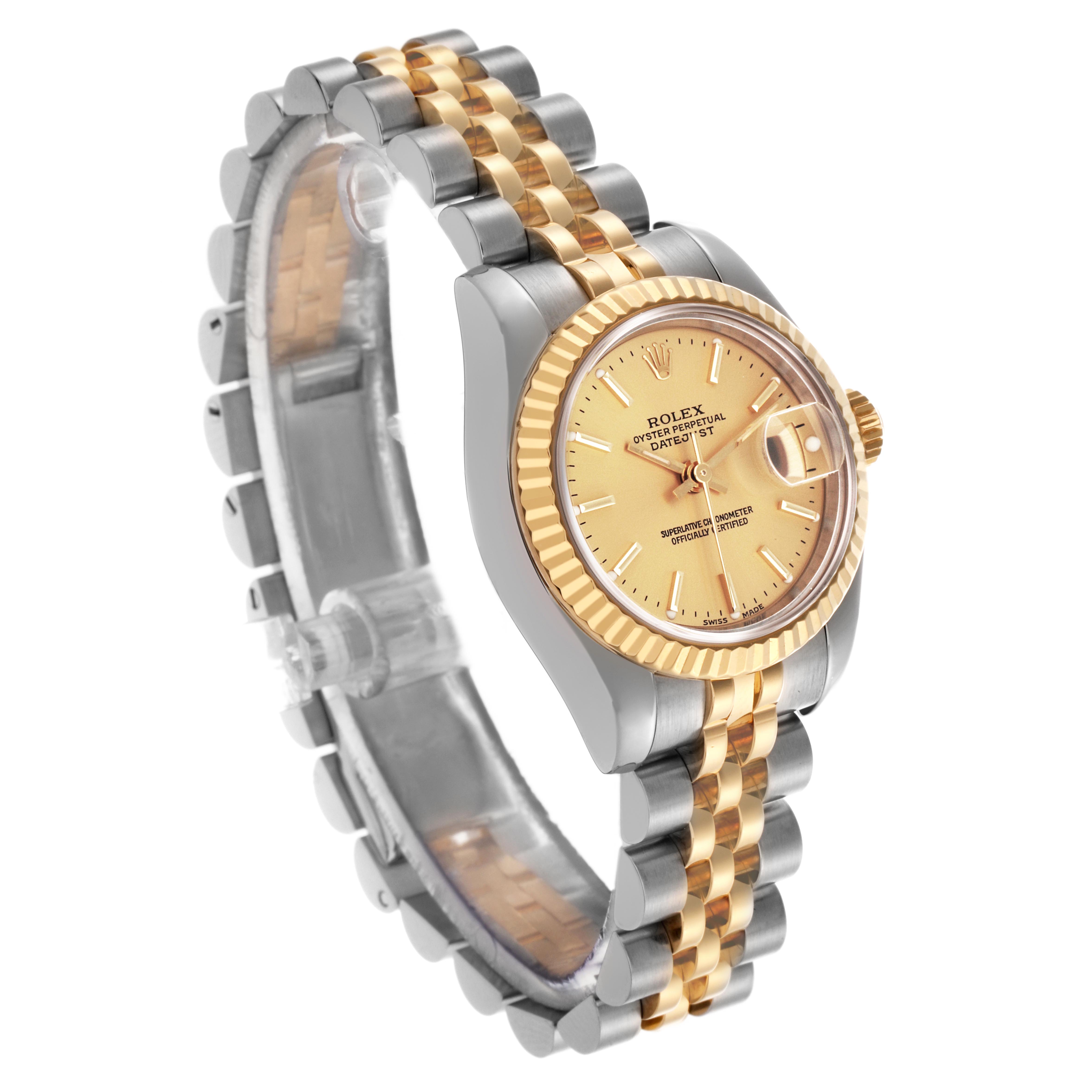 The Rolex Datejust 179173 Women's Steel and Gold (two tone) Champagne Dial 179173 Women's Steel and Gold (two tone) Champagne Dial watch is shown at a slight angle, displaying the watch face, fluted bezel, and two-tone bracelet.