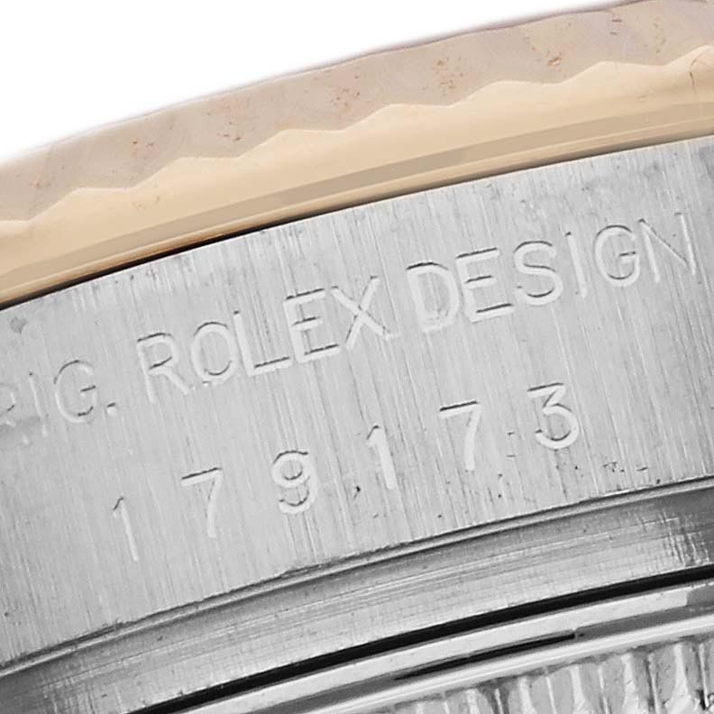 The image shows a close-up of the side casing of a Rolex Datejust 179173 Women's Steel and Gold (two tone) Champagne Dial 179173 Women's Steel and Gold (two tone) Champagne Dial, highlighting the engraved model number and design text.