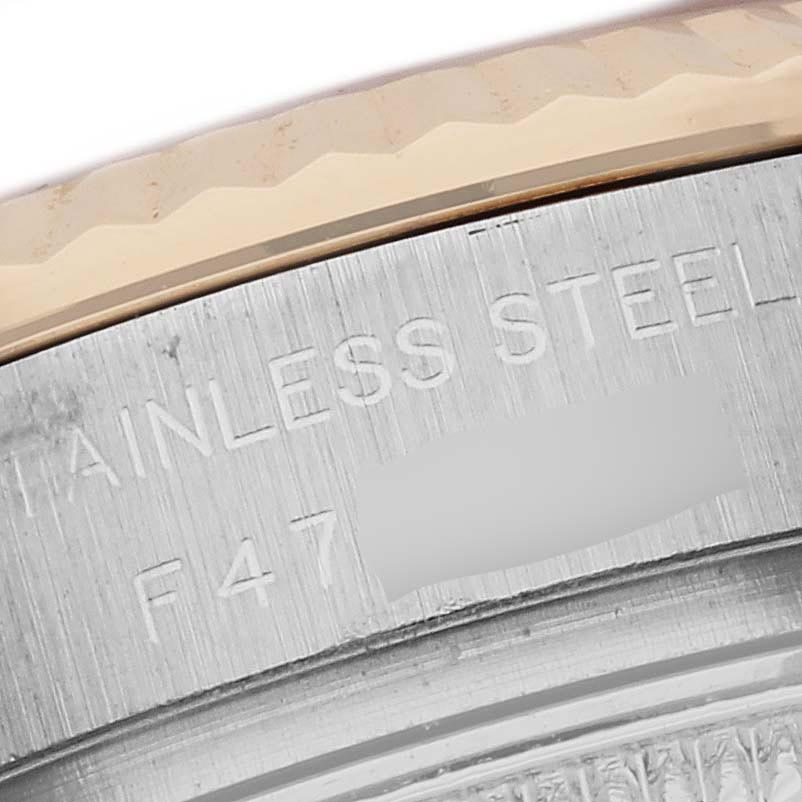 The image shows a close-up of the watch's stainless steel edge with engravings on the Rolex Datejust 179173 Women's Steel and Gold (two tone) Champagne Dial 179173 Women's Steel and Gold (two tone) Champagne Dial.