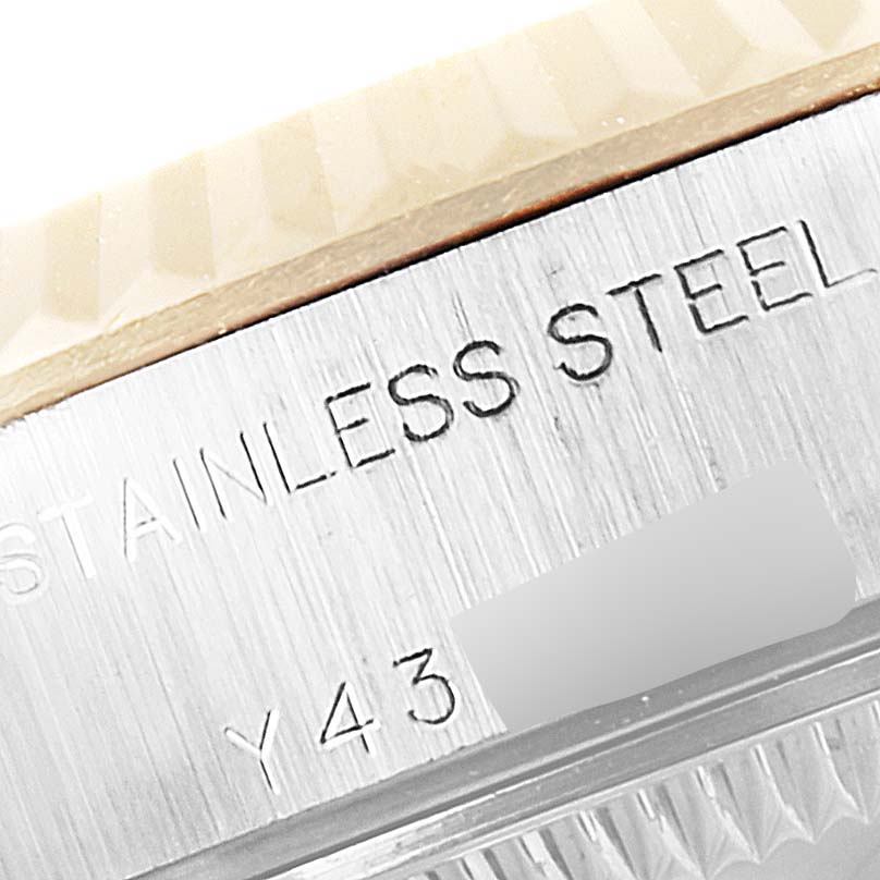 The image shows a close-up of the edge of the stainless steel casing of a Rolex Datejust 79173 Women's Steel and Gold (two tone) Mother of Pearl Dial 79173 Women's Steel and Gold (two tone) Mother of Pearl Dial watch.