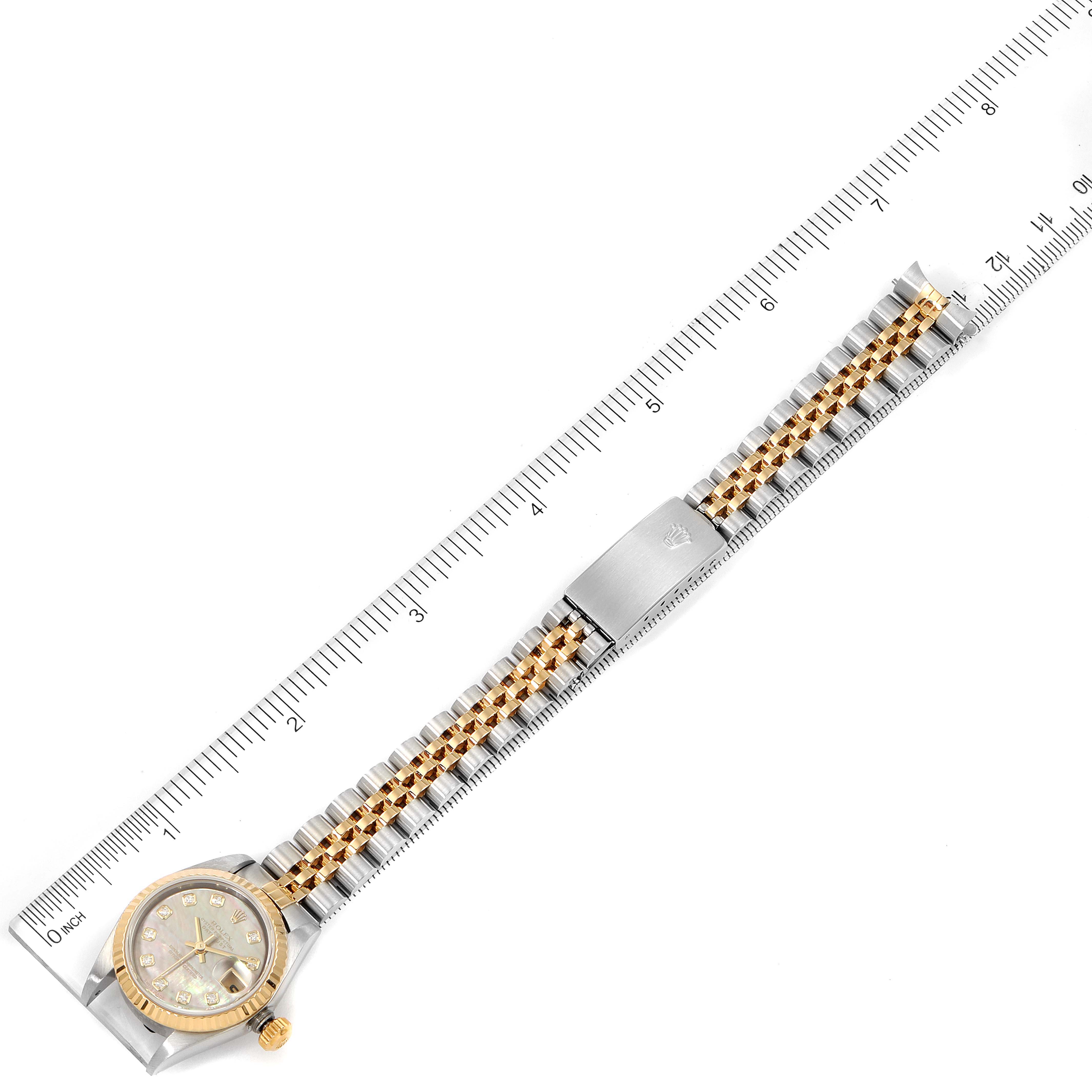 The image shows a full-length top view of a Rolex Datejust 79173 Women's Steel and Gold (two tone) Mother of Pearl Dial 79173 Women's Steel and Gold (two tone) Mother of Pearl Dial watch, with the face, bracelet, and clasp visible, alongside a ruler for scale.