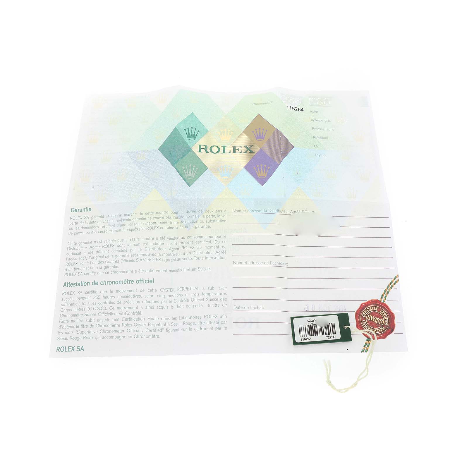 The image shows a Rolex Turn-o-Graph 116264 Men's Stainless Steel Blue Dial warranty card with a tag and seal, laid flat from a top view.