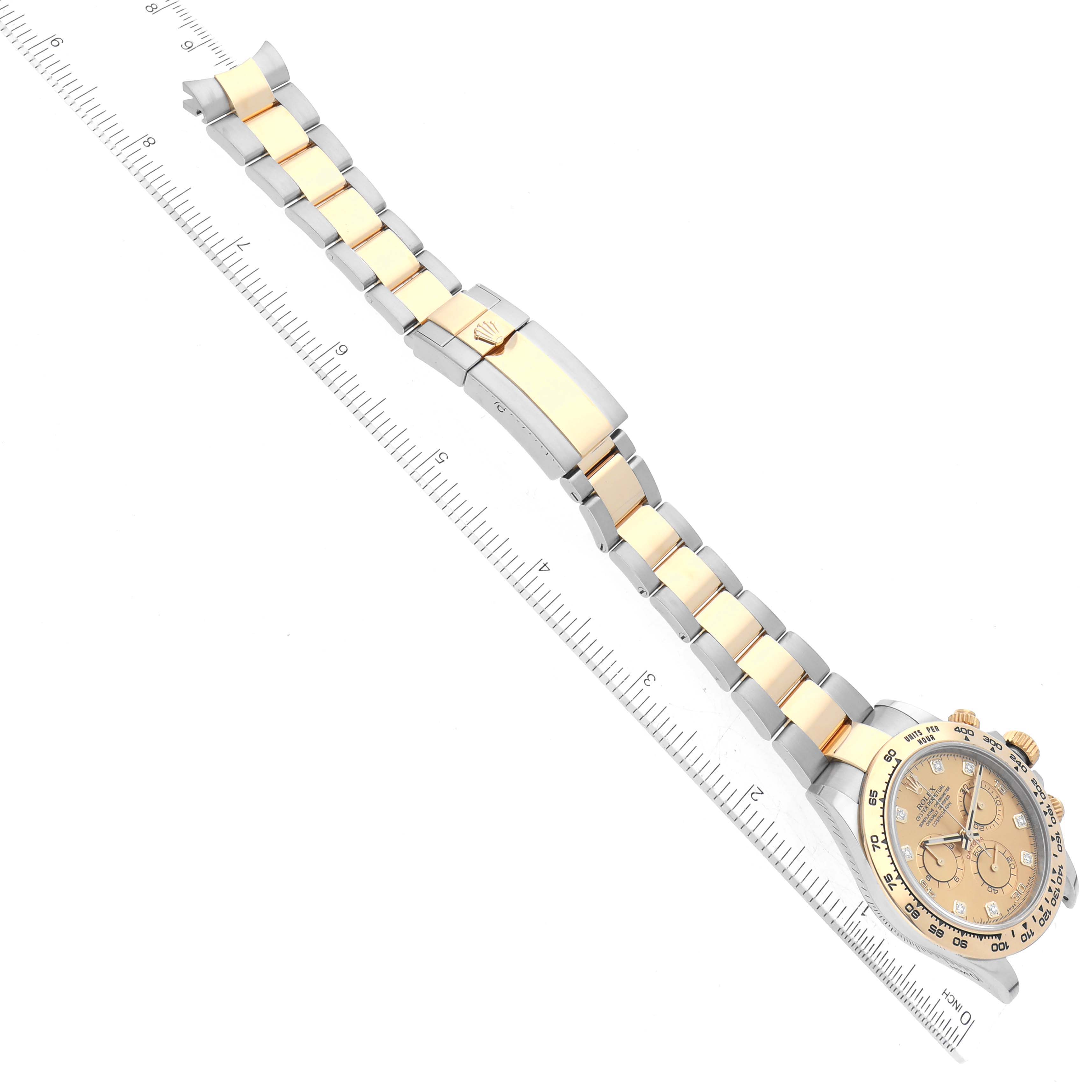 The image shows a Rolex Daytona 116503 Men's Steel and Gold (two tone) Champagne Dial 116503 Men's Steel and Gold (two tone) Champagne Dial watch, showcasing its face, bezel, and two-tone metal bracelet with a ruler for scale.