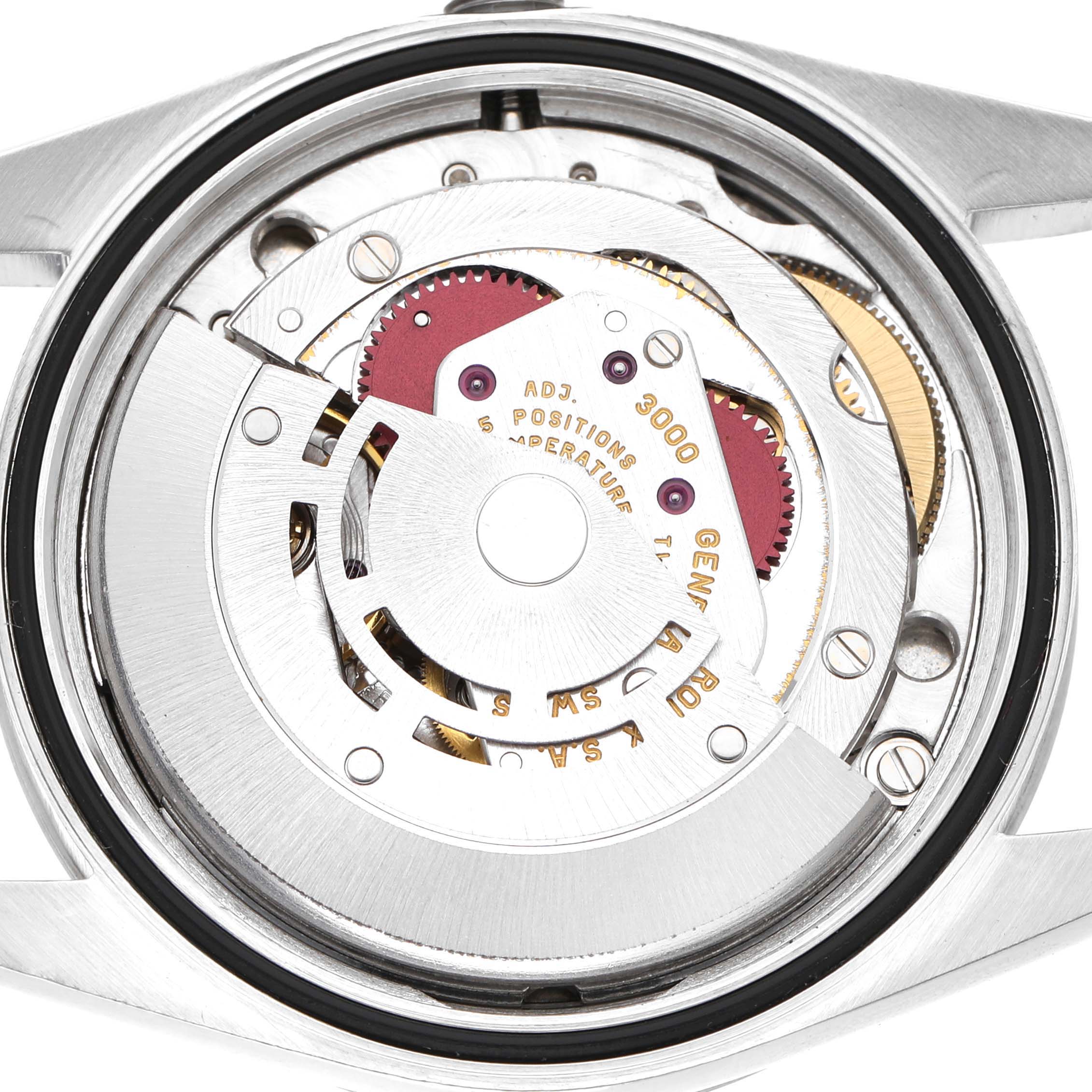 The image shows the movement of a Rolex Explorer 14270 Men's Stainless Steel Black Dial watch from a top-down angle, highlighting gears and rotor.