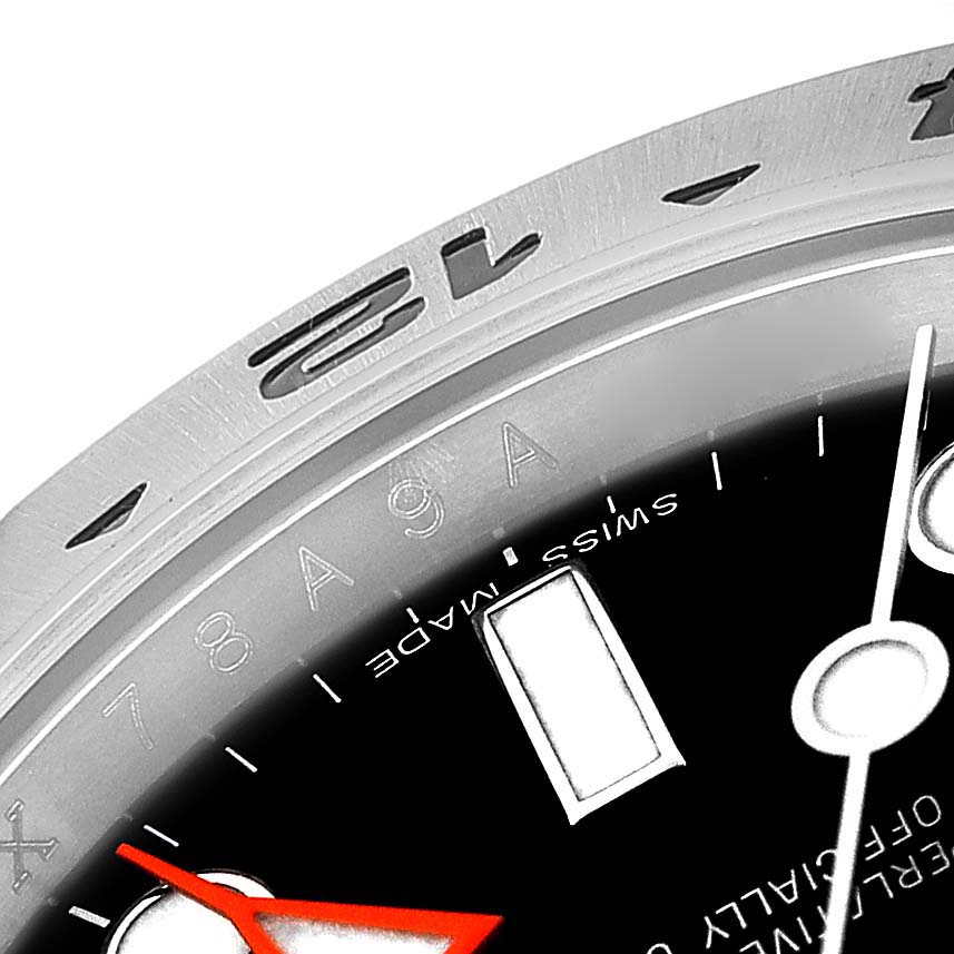 The image shows a close-up angle of the watch face and bezel of the Rolex Explorer 216570 Men
s Stainless Steel Black Dial 216570 Men
s Stainless Steel Black Dial model, highlighting the hour markers, a red second hand, and part of the bezel numbers.