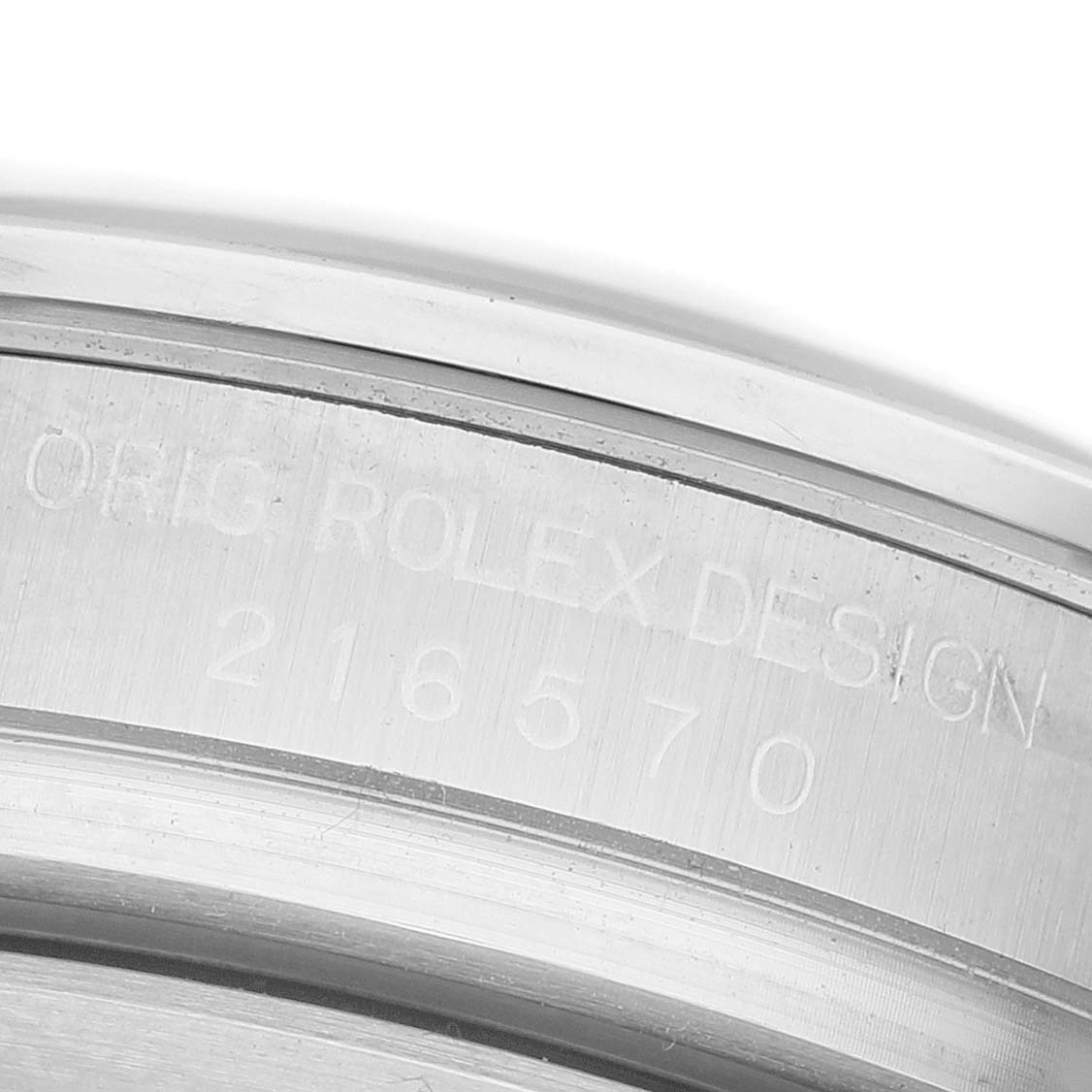 The image shows a close-up of the case side with engravings of the Rolex Explorer 216570 Men's Stainless Steel Black Dial's model number and design details.