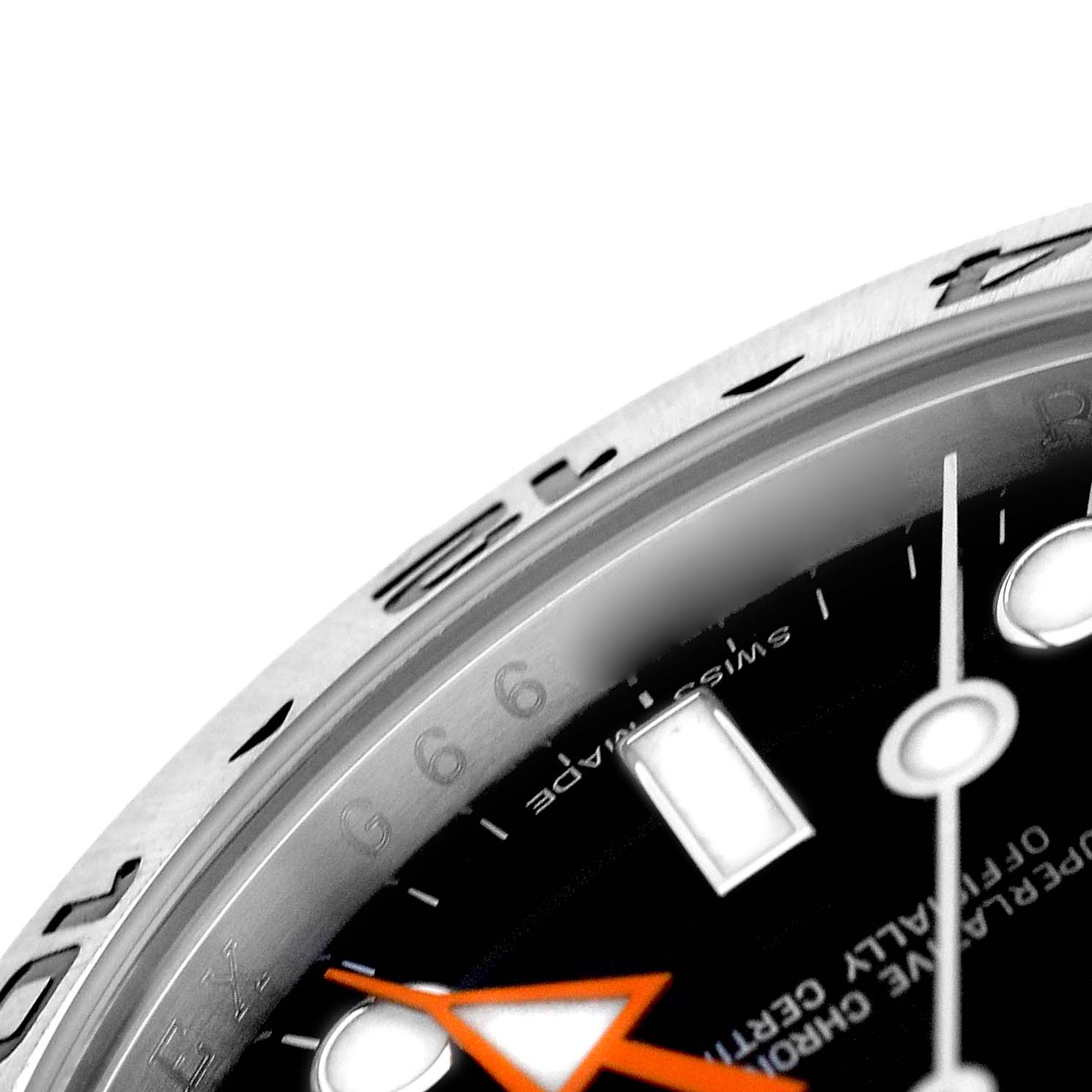 The image shows a close-up of the dial and bezel of a Rolex Explorer 216570 Men's Stainless Steel Black Dial watch, highlighting the hour markers and hands.