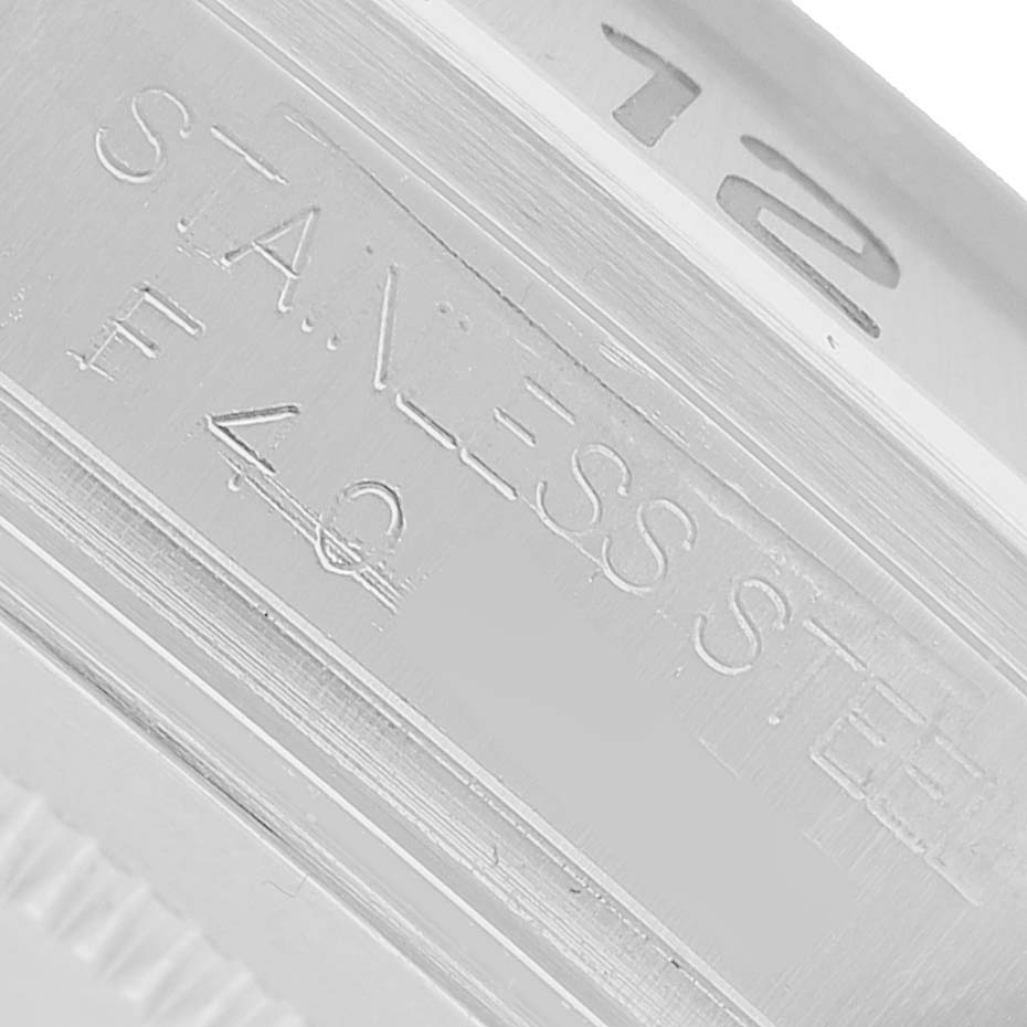 The image shows a close-up of the Rolex Explorer 16570 Men's Stainless Steel White Dial’s stainless steel case with partial engraving details.