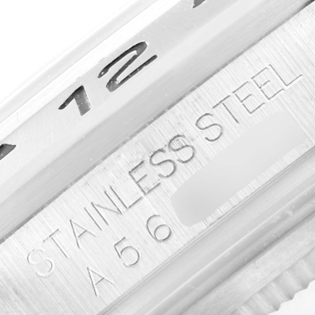 The image shows a close-up of the bezel and casing of a Rolex Explorer 16570 Men
s Stainless Steel White Dial 16570 Men
s Stainless Steel White Dial watch, highlighting the "STAINLESS STEEL" engraving.