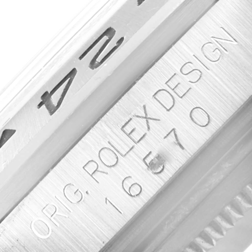 The image shows a close-up of the side of a Rolex Explorer 16570 Men
s Stainless Steel White Dial 16570 Men
s Stainless Steel White Dial model, focusing on the engraved serial and model numbers.