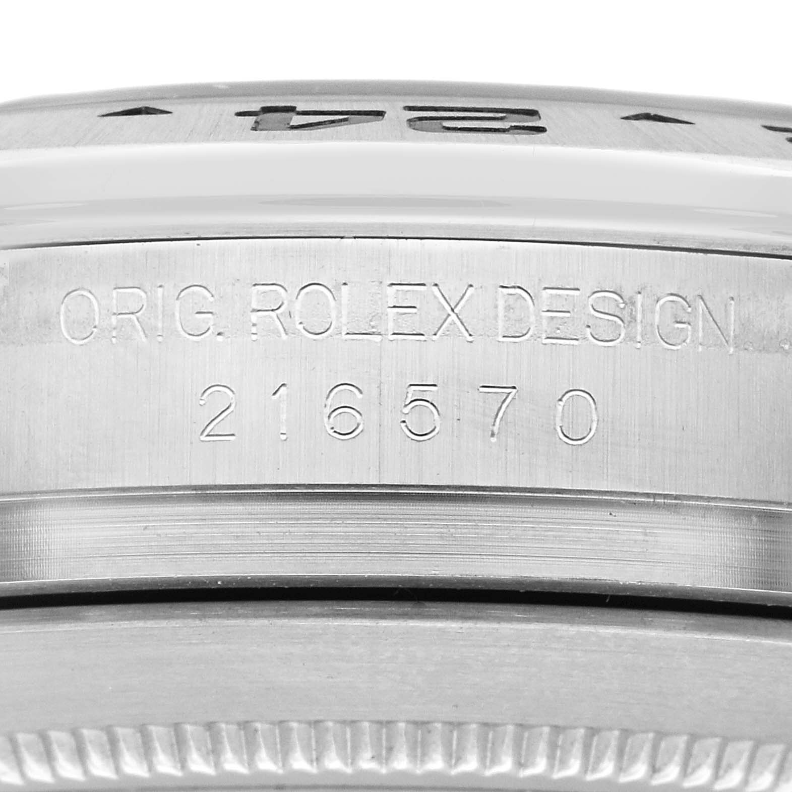 The image shows a close-up of the side of a Rolex Explorer 216570 Men
s Stainless Steel White Dial 216570 Men
s Stainless Steel White Dial watch, displaying the model number 216570 and "Orig. Rolex Design" engraving.