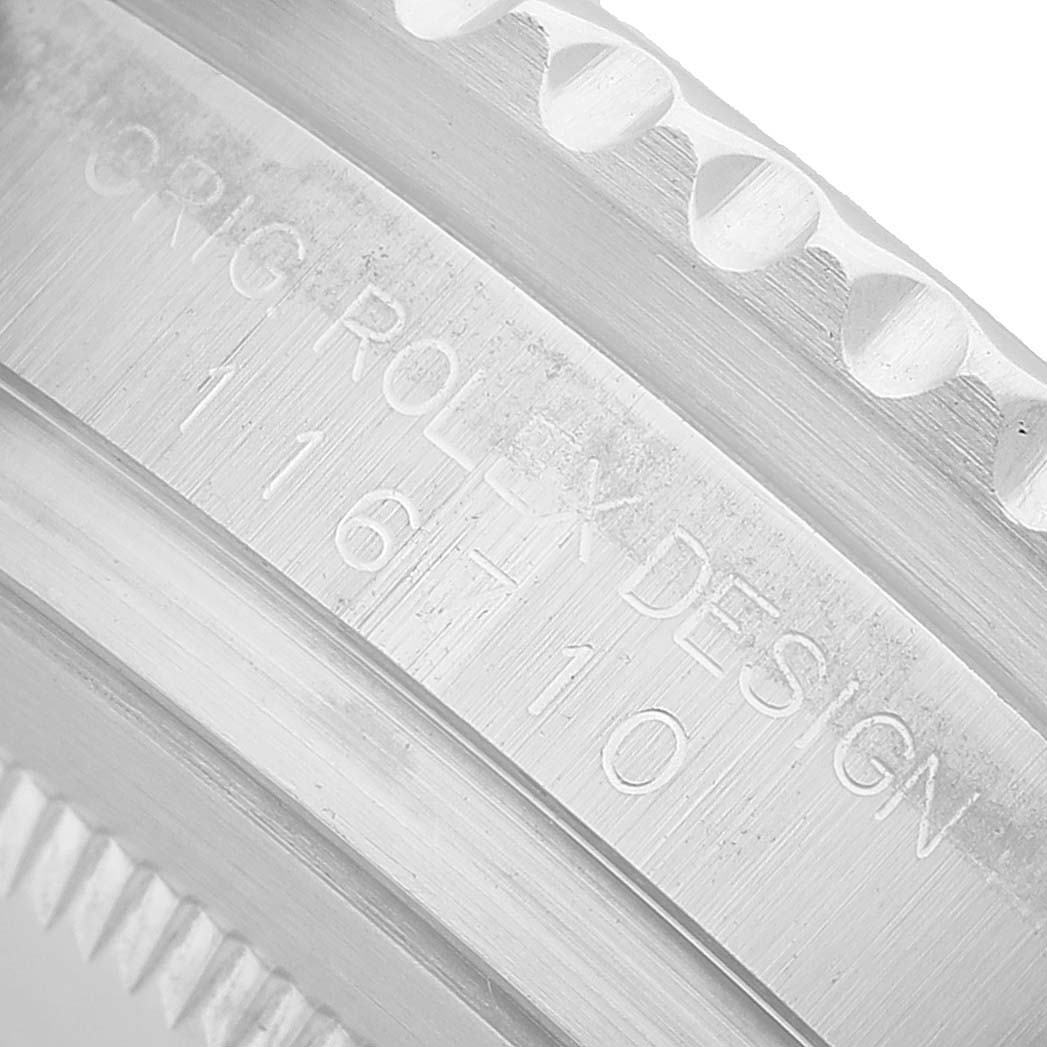 The image shows a close-up of the edge and engraved side of the Rolex GMT-Master 116710 Men's Stainless Steel Black Dial bezel, focusing on model details.