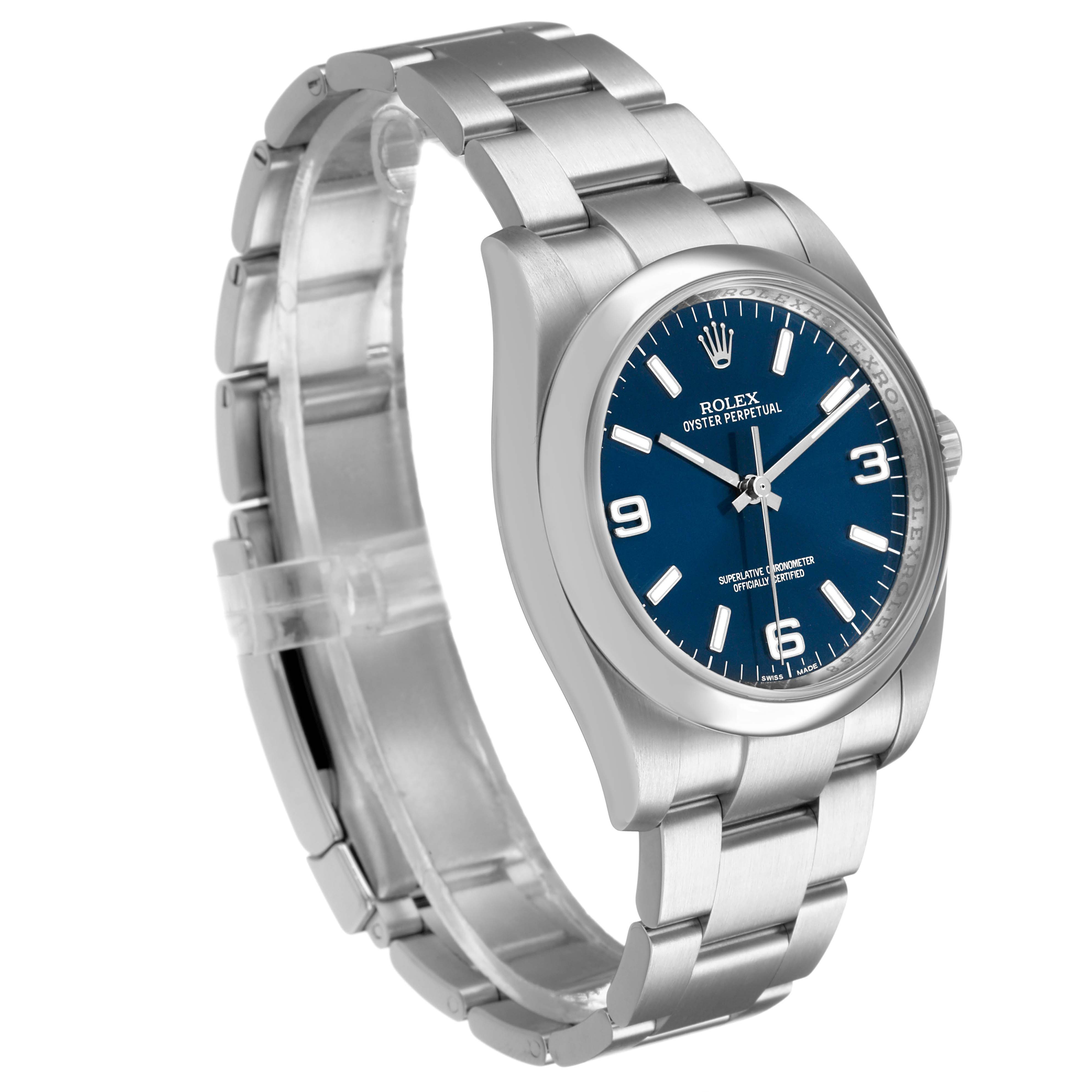 The Rolex Oyster Perpetual 116000 Men's Stainless Steel Blue Dial watch is shown at a slight angle, displaying the bracelet, case, and blue dial.