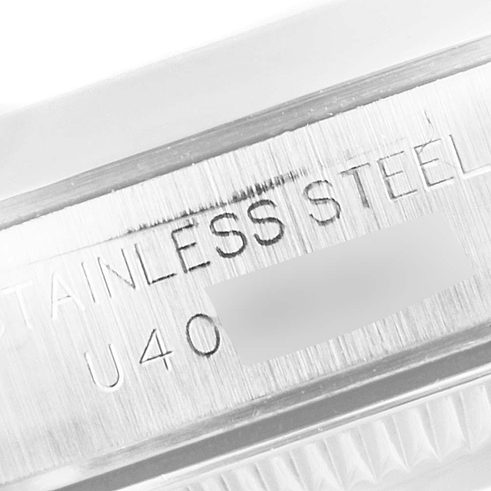 This image shows a close-up view of the stainless steel part with an engraving on the Rolex Oyster Perpetual 67180 Women
s Stainless Steel Blue Dial 67180 Women
s Stainless Steel Blue Dial watch.