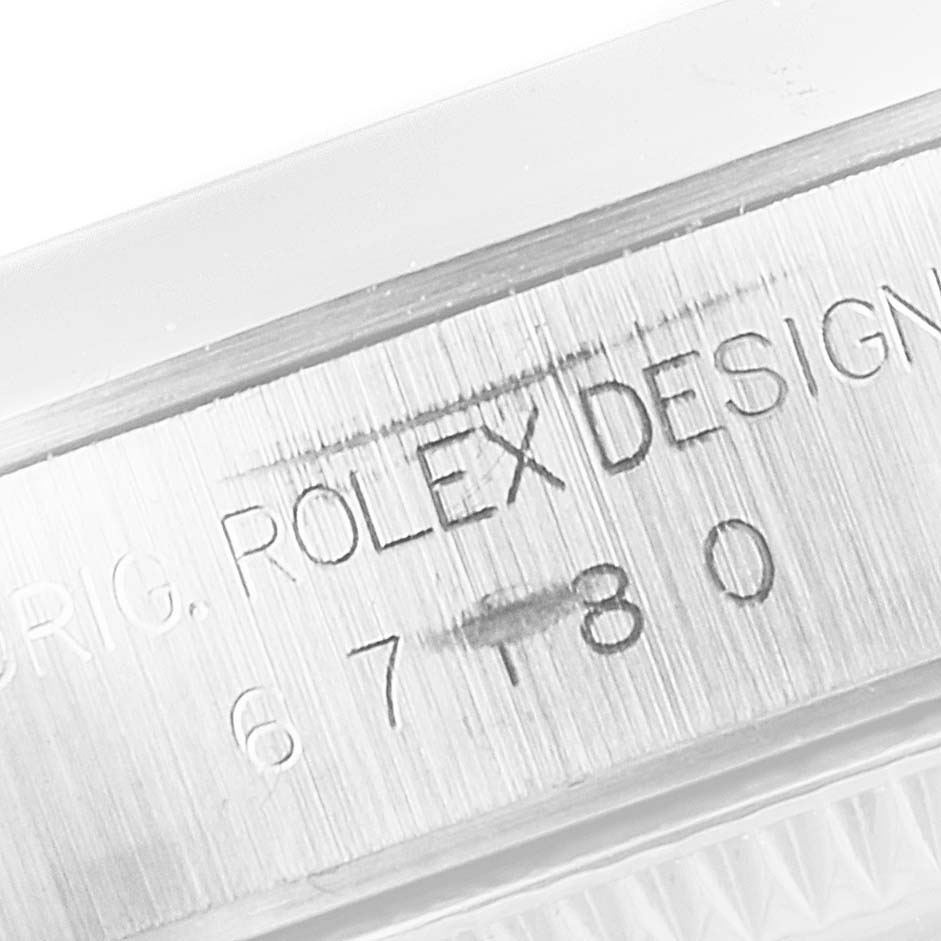 This is a close-up shot of the engravings on the side of a Rolex Oyster Perpetual 67180 Women
s Stainless Steel Blue Dial 67180 Women
s Stainless Steel Blue Dial watch case.