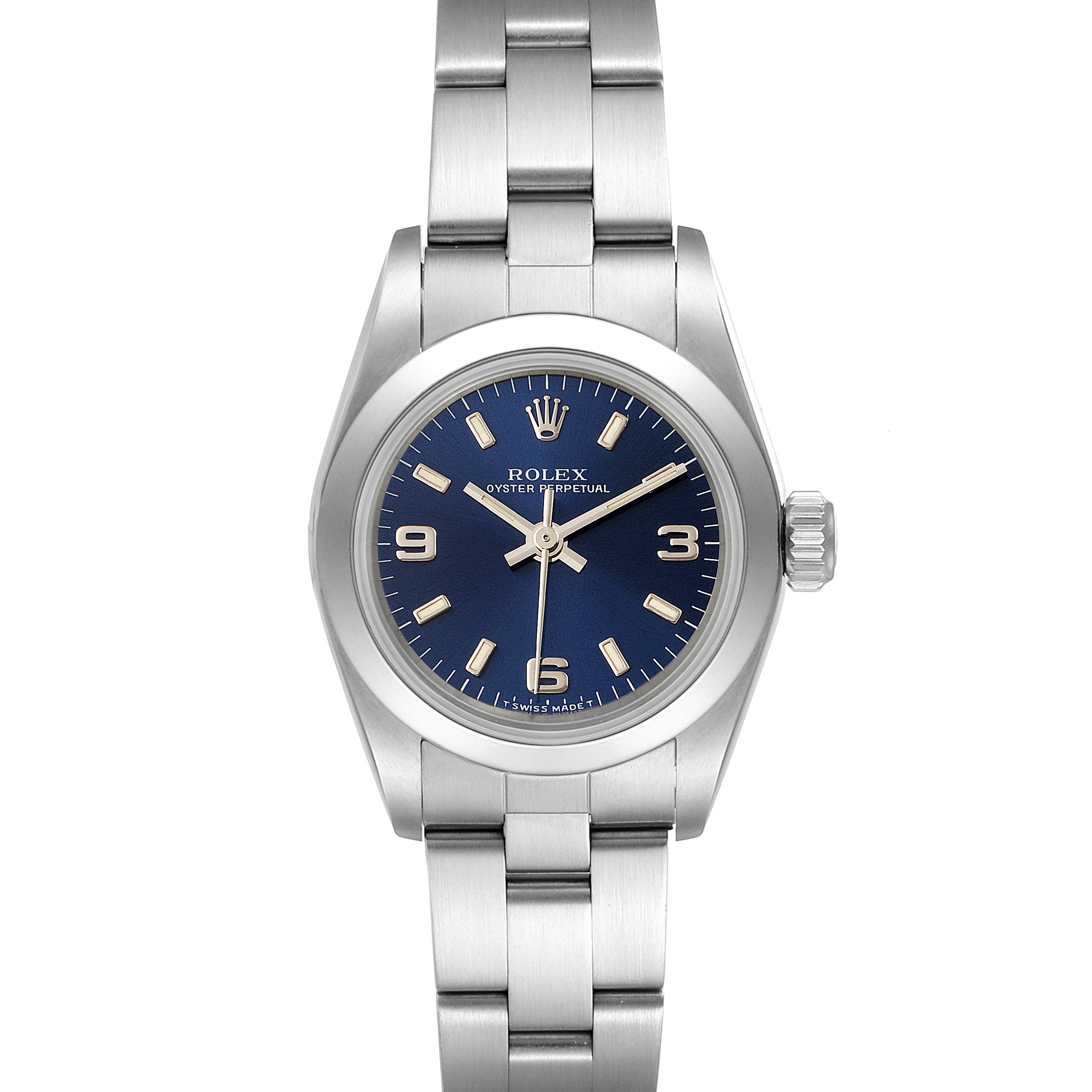 The image shows a front view of a Rolex Oyster Perpetual 67180 Women
s Stainless Steel Blue Dial 67180 Women
s Stainless Steel Blue Dial watch with a blue dial and stainless steel bracelet.