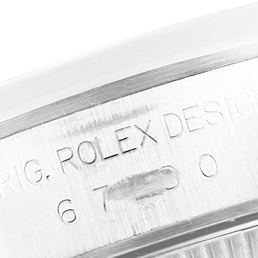 This image shows a close-up of the engraved model details on the side of a Rolex Oyster Perpetual 67180 Women's Stainless Steel White Dial 67180 Women's Stainless Steel White Dial watch.