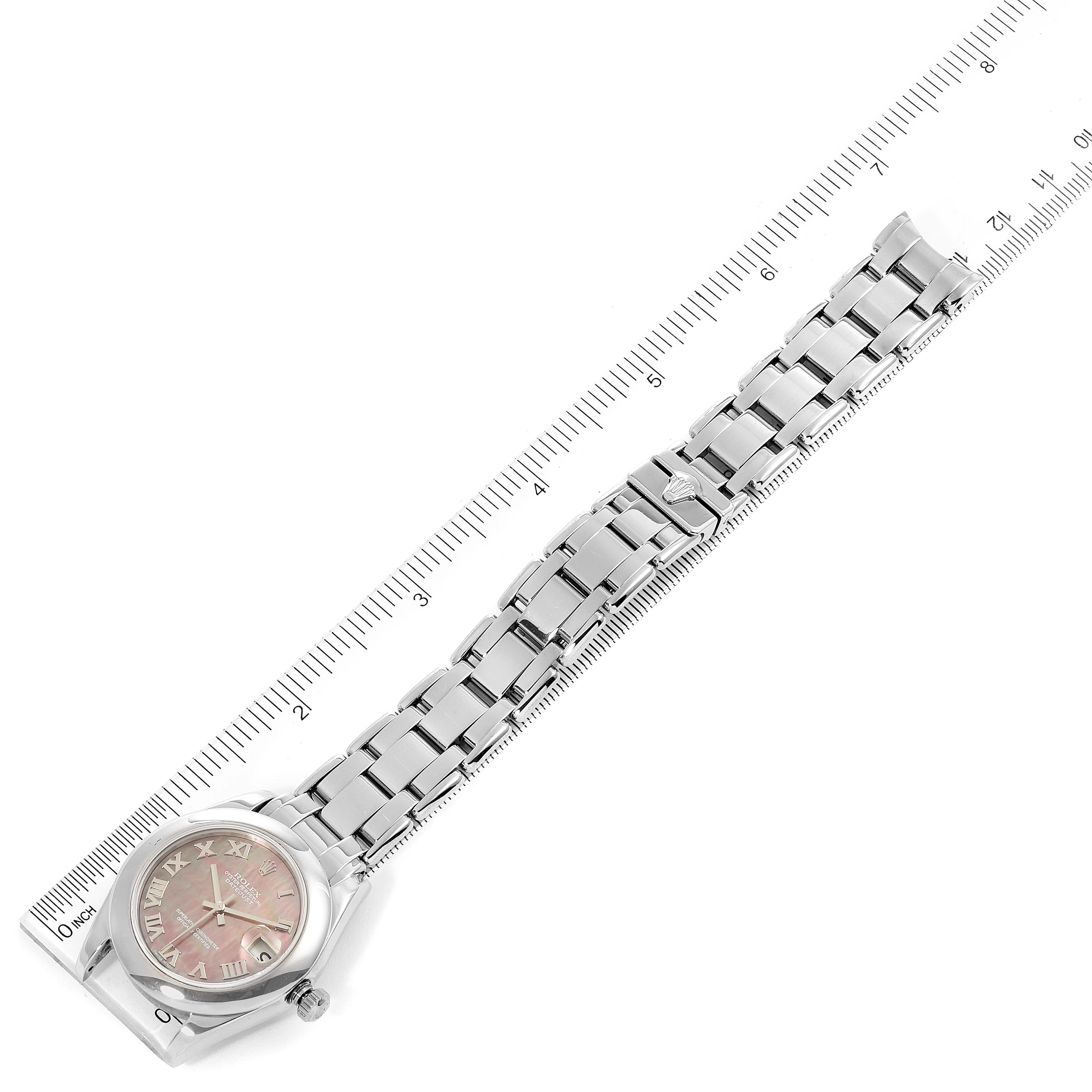 This image shows a top-down view of a Rolex Pearlmaster 81209 Women's White Gold Mother of Pearl Dial 81209 Women's White Gold Mother of Pearl Dial watch with its full bracelet aligned next to a ruler for scale.