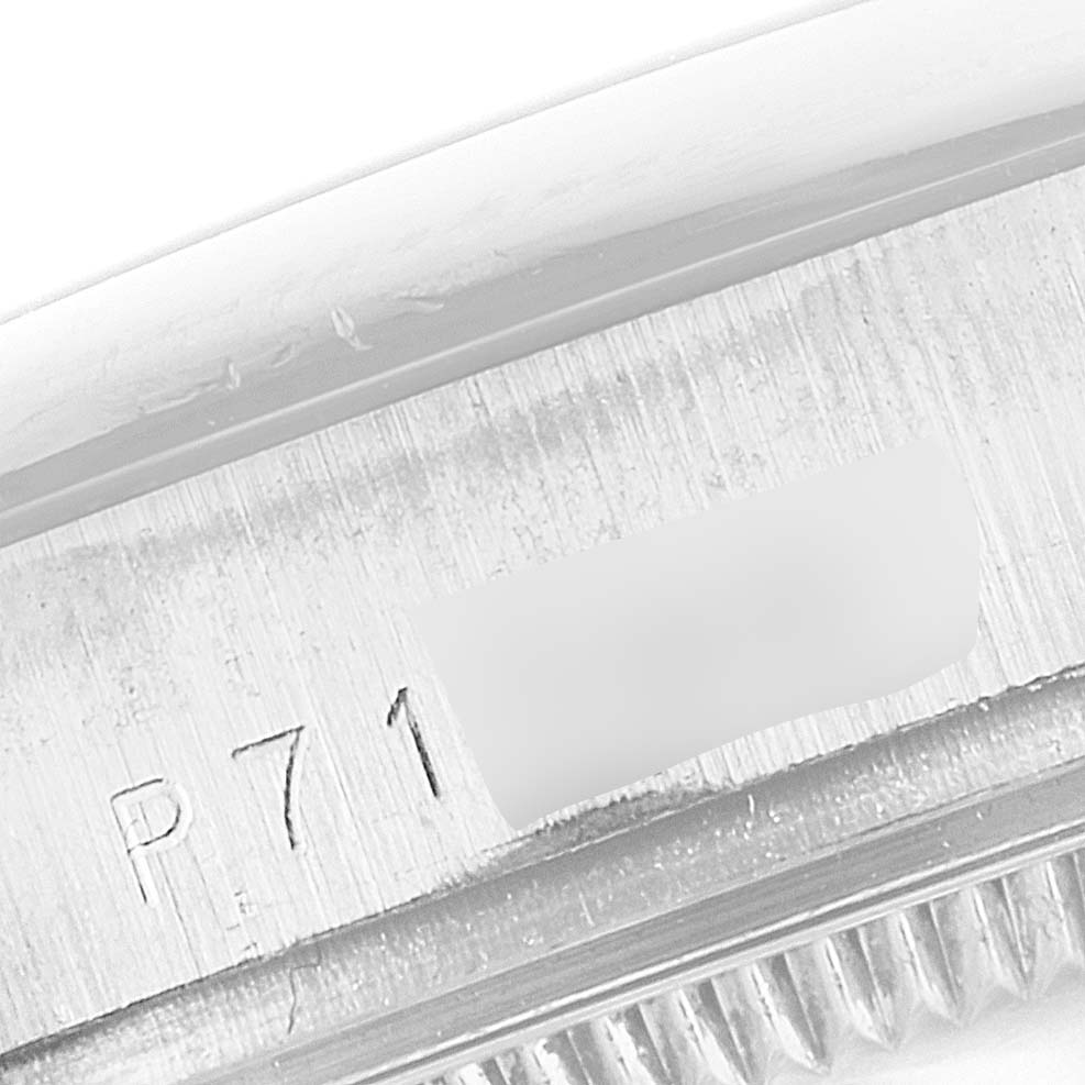 This close-up photograph showcases the side engraving of a Rolex Pearlmaster 81209 Women's White Gold Mother of Pearl Dial 81209 Women's White Gold Mother of Pearl Dial watch, including partial serial number details.