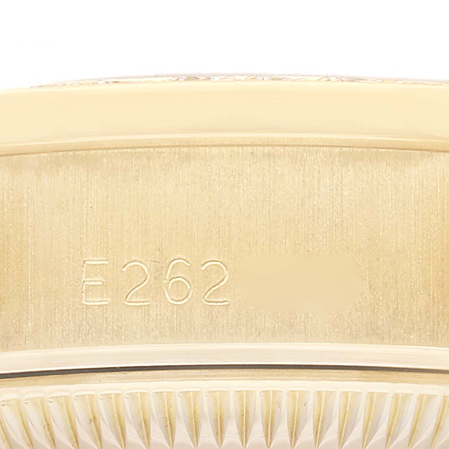 This image shows a close-up of the serial number engraved on the case of a Rolex President 69138G Women
s Yellow Gold Champagne Dial 69138G Women
s Yellow Gold Champagne Dial model watch.