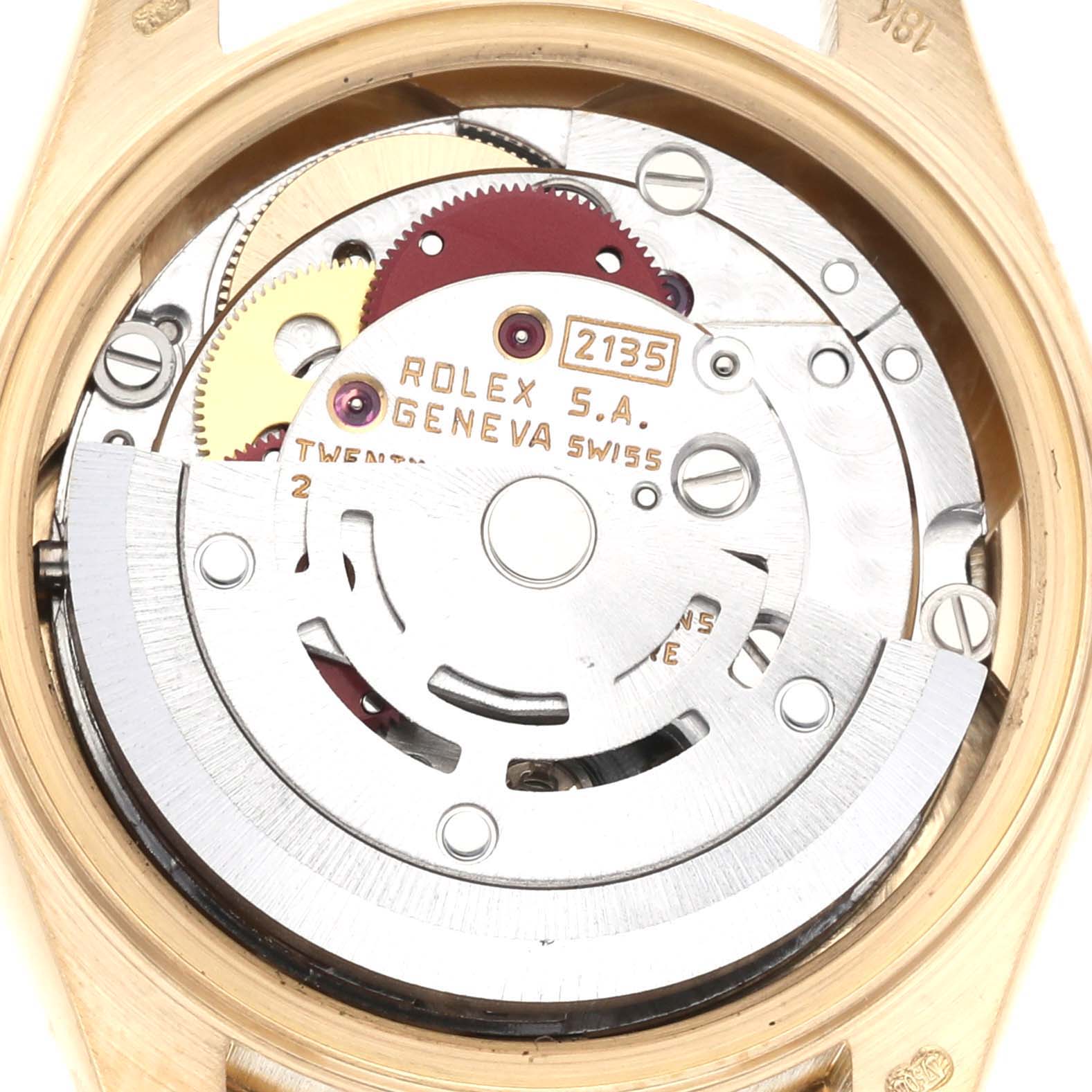The image shows a close-up of the interior mechanism of a Rolex President 69138G Women
s Yellow Gold Champagne Dial 69138G Women
s Yellow Gold Champagne Dial model watch, highlighting its gears and movement components.