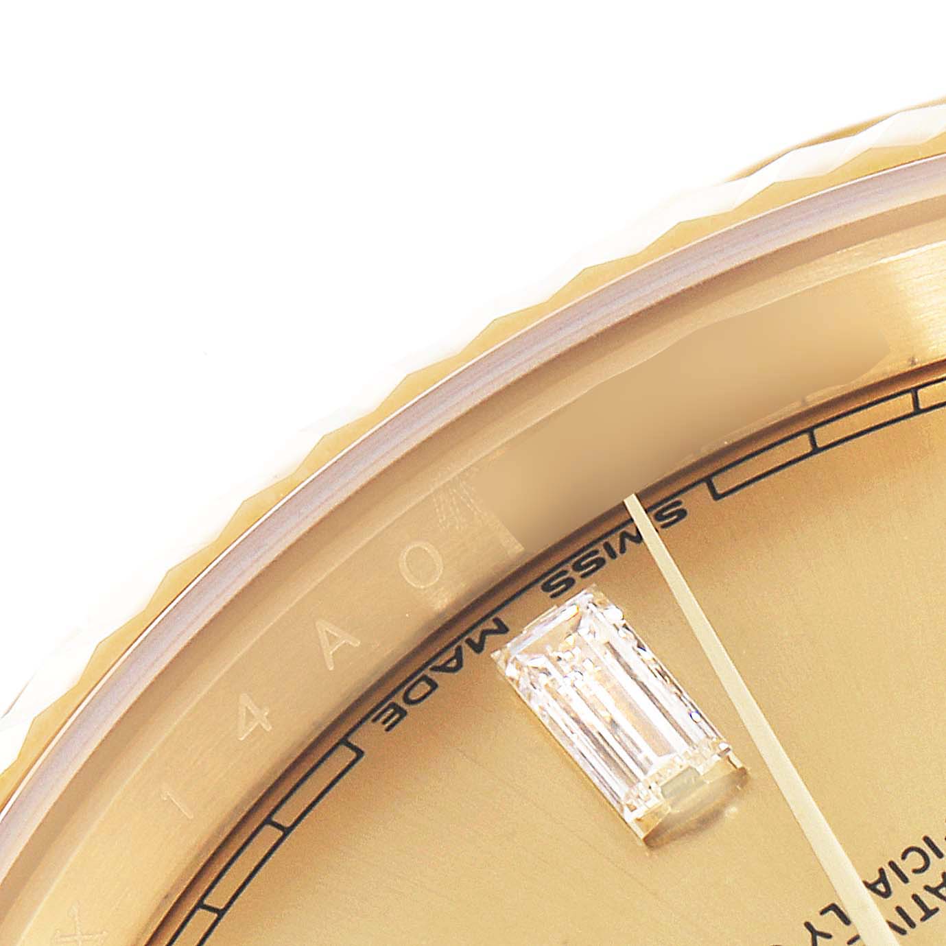 This close-up angle of the Rolex President 228238 Men's Yellow Gold Champagne Dial 228238 Men's Yellow Gold Champagne Dial watch shows part of the bezel, dial, and a diamond hour marker.