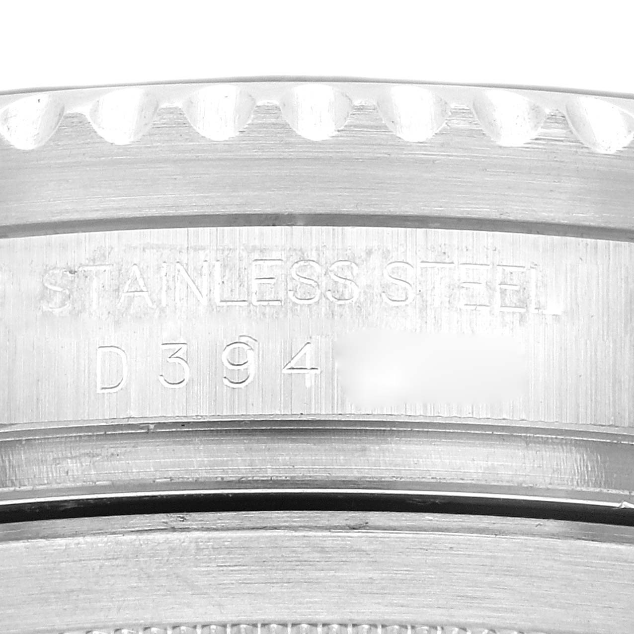 This image shows a close-up of the side of a Rolex Sea-Dweller 16600 Men's Stainless Steel Black Dial 16600 Men's Stainless Steel Black Dial watch, highlighting the serial number and "STAINLESS STEEL" engraving.