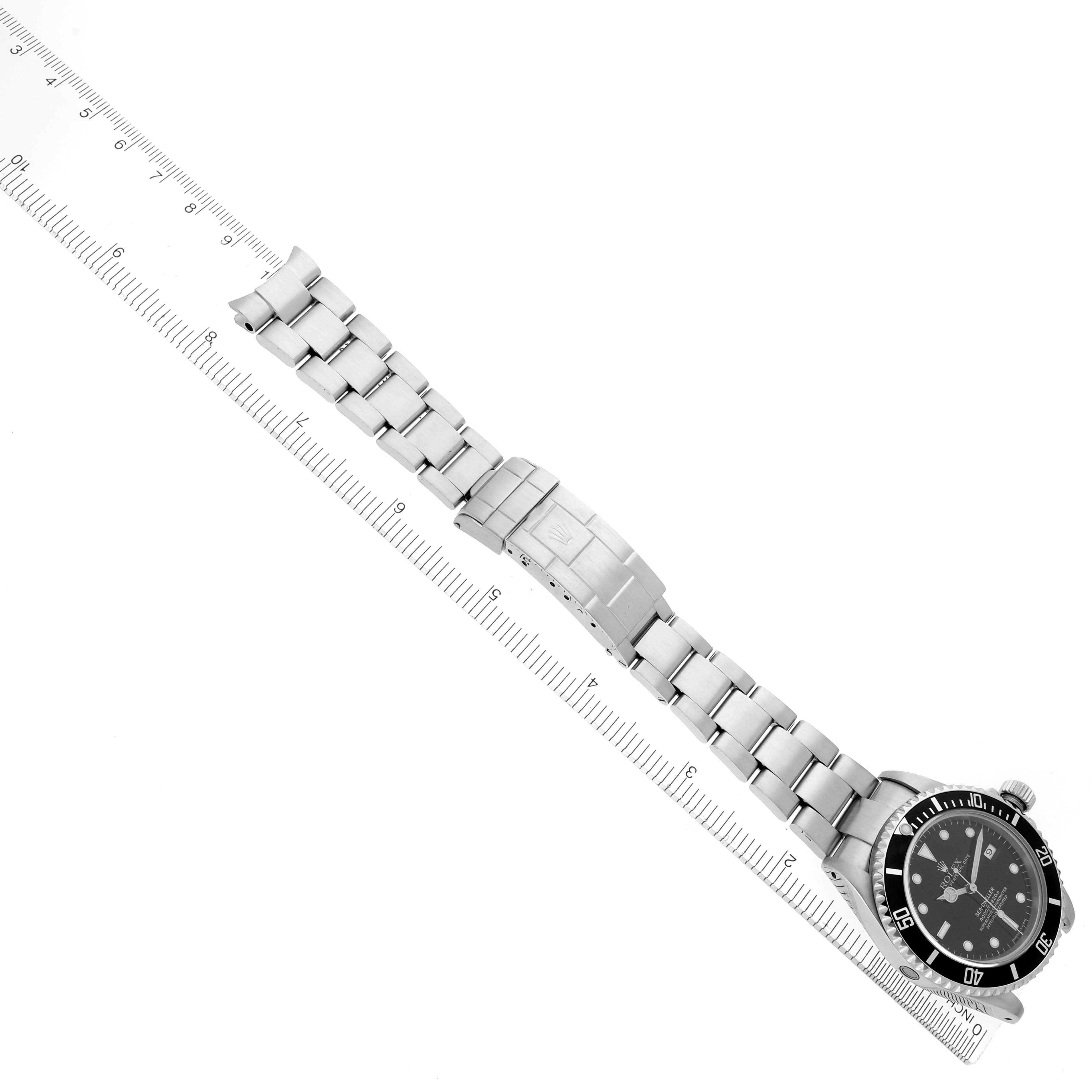 The Rolex Sea-Dweller 16600 Men's Stainless Steel Black Dial 16600 Men's Stainless Steel Black Dial watch is shown at an angle, displaying the face, bezel, bracelet, and clasp alongside a ruler.