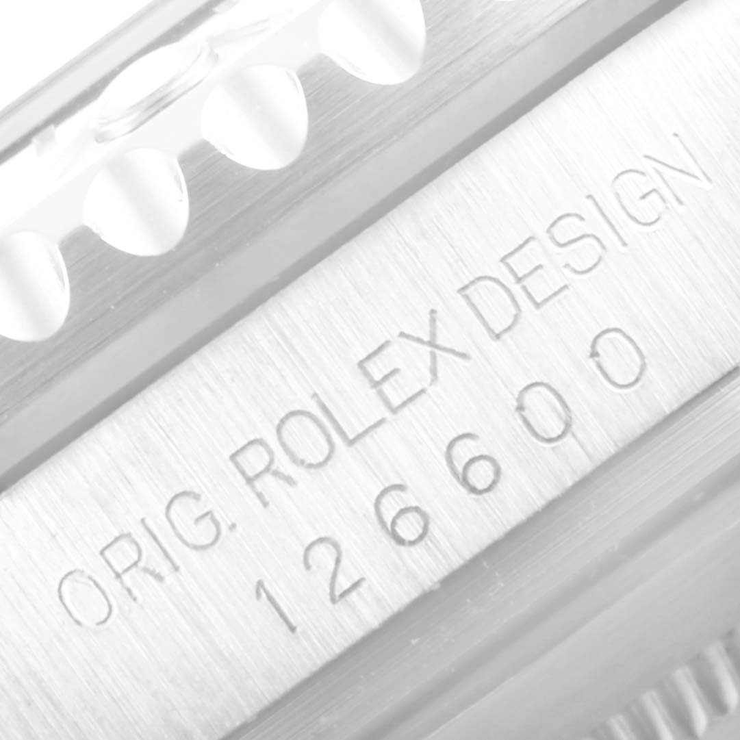 The image shows a close-up of the model number and bezel of a Rolex Sea-Dweller 126600 Men
s Stainless Steel Black Dial 126600 Men
s Stainless Steel Black Dial watch, highlighting the "Orig. Rolex Design 126600" engraving.