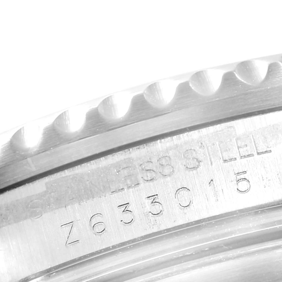 This image shows a close-up angle of the engraved serial number on the case of a Rolex Submariner 16610 Men
s Stainless Steel Black Dial 16610 Men
s Stainless Steel Black Dial watch.