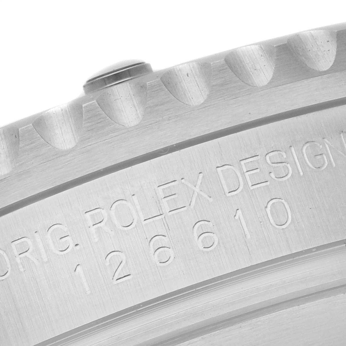 This image shows a close-up of the engraved side of the bezel of a Rolex Submariner 126610LN Men
s Stainless Steel Black Dial 126610LN Men
s Stainless Steel Black Dial watch, displaying part of its serial number.