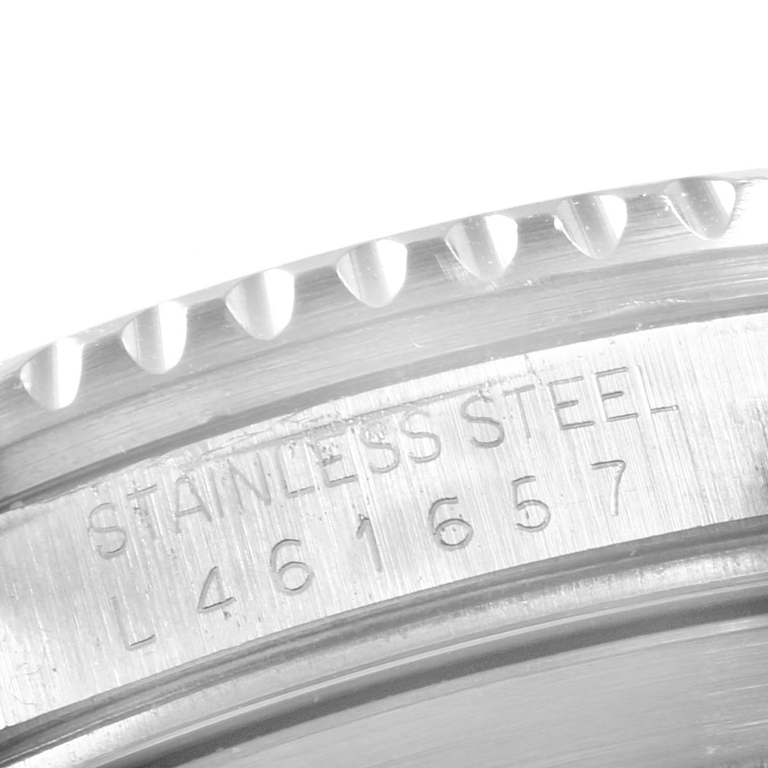 This image shows a close-up of the engraved reference number and fluted bezel of a Rolex Submariner 16610 Men
s Stainless Steel Black Dial 16610 Men
s Stainless Steel Black Dial watch.