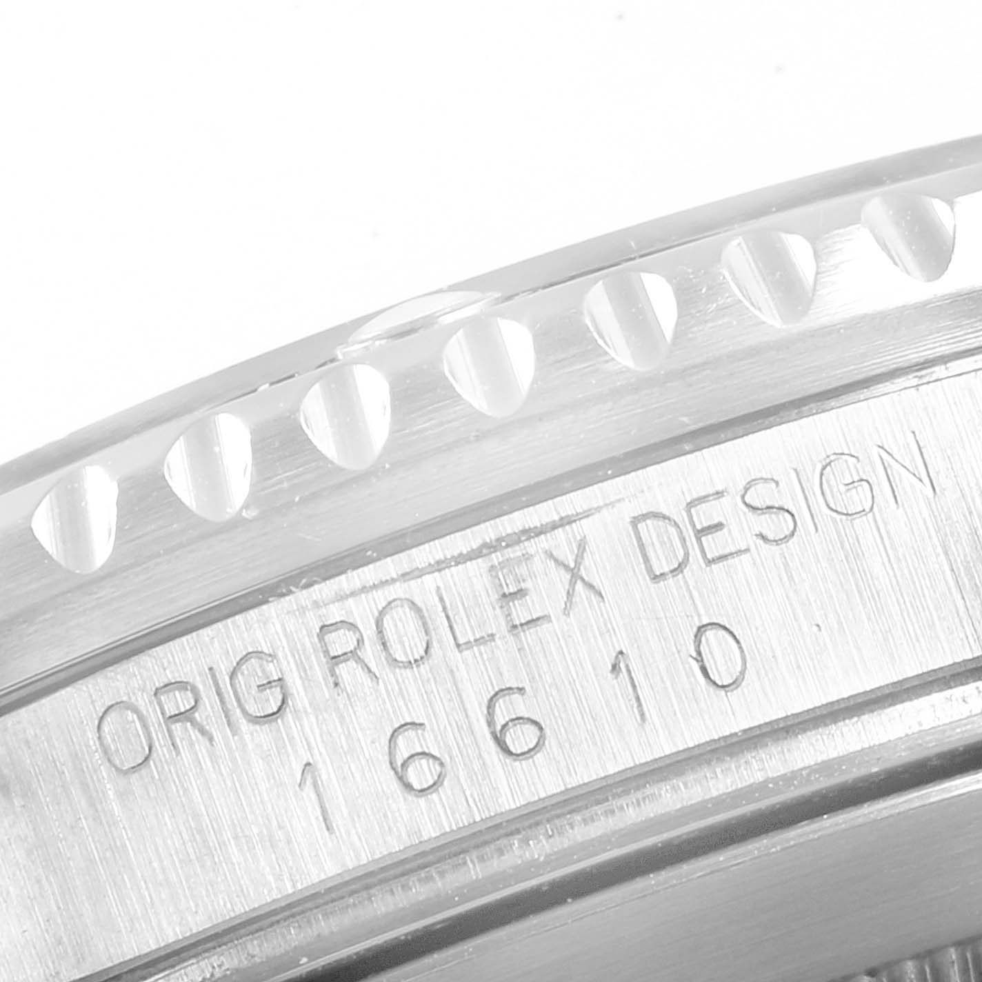 The image shows a close-up of the side of a Rolex Submariner 16610 Men
s Stainless Steel Black Dial 16610 Men
s Stainless Steel Black Dial bezel, featuring model number 16610 and the text "ORIG ROLEX DESIGN."