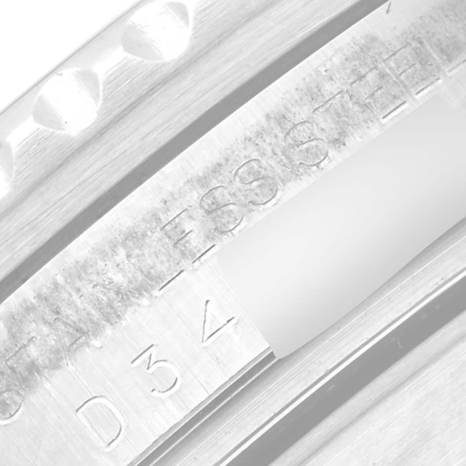 This close-up image shows part of the stainless steel case back and serial number engraving of a Rolex Submariner 16610 Men
s Stainless Steel Black Dial 16610 Men
s Stainless Steel Black Dial watch.