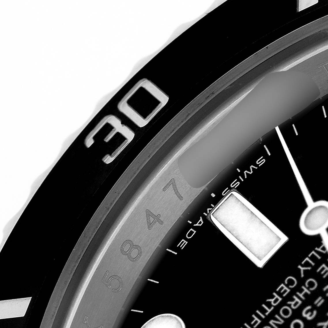 This image shows a close-up of the bezel and part of the dial of a Rolex Submariner 116610 Men's Stainless Steel Black Dial watch, focusing on the 30-minute marker.