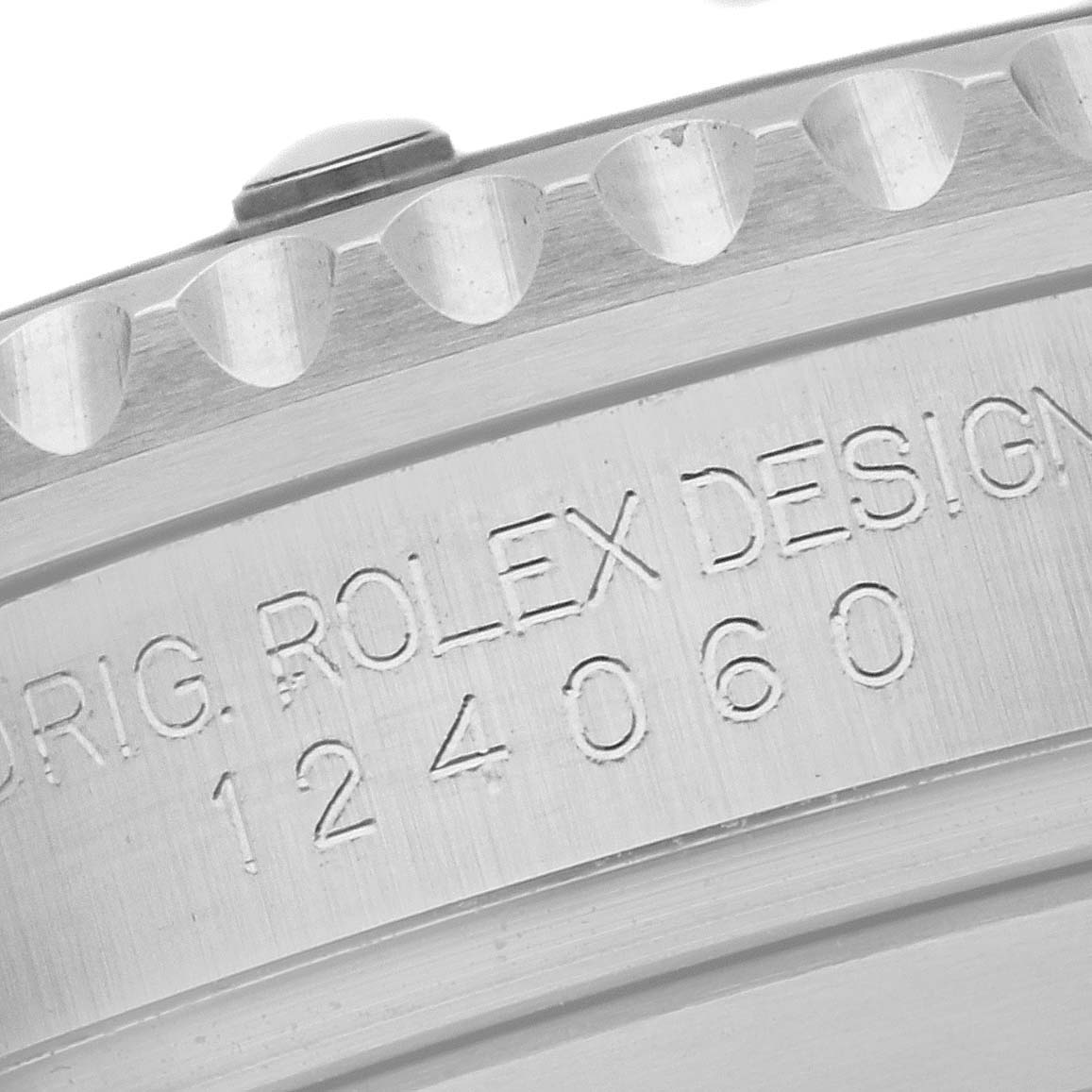 This close-up image shows the engraved case back of the Rolex Submariner 124060 Men's Stainless Steel Black Dial 124060 Men's Stainless Steel Black Dial, highlighting the "Orig. Rolex Design" and model number 124060.