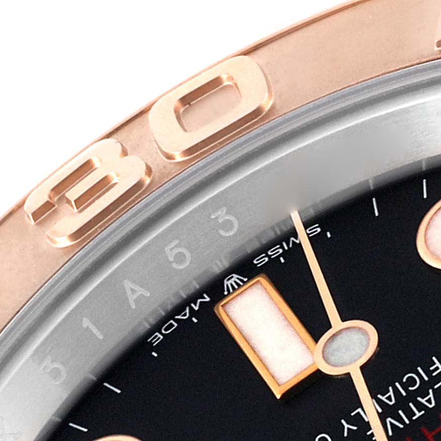 This close-up image shows the bezel, part of the dial, and luminescent hour markers of a Rolex Yacht-Master 126621 Men's Steel and Gold (two tone) Black Dial 126621 Men's Steel and Gold (two tone) Black Dial watch.