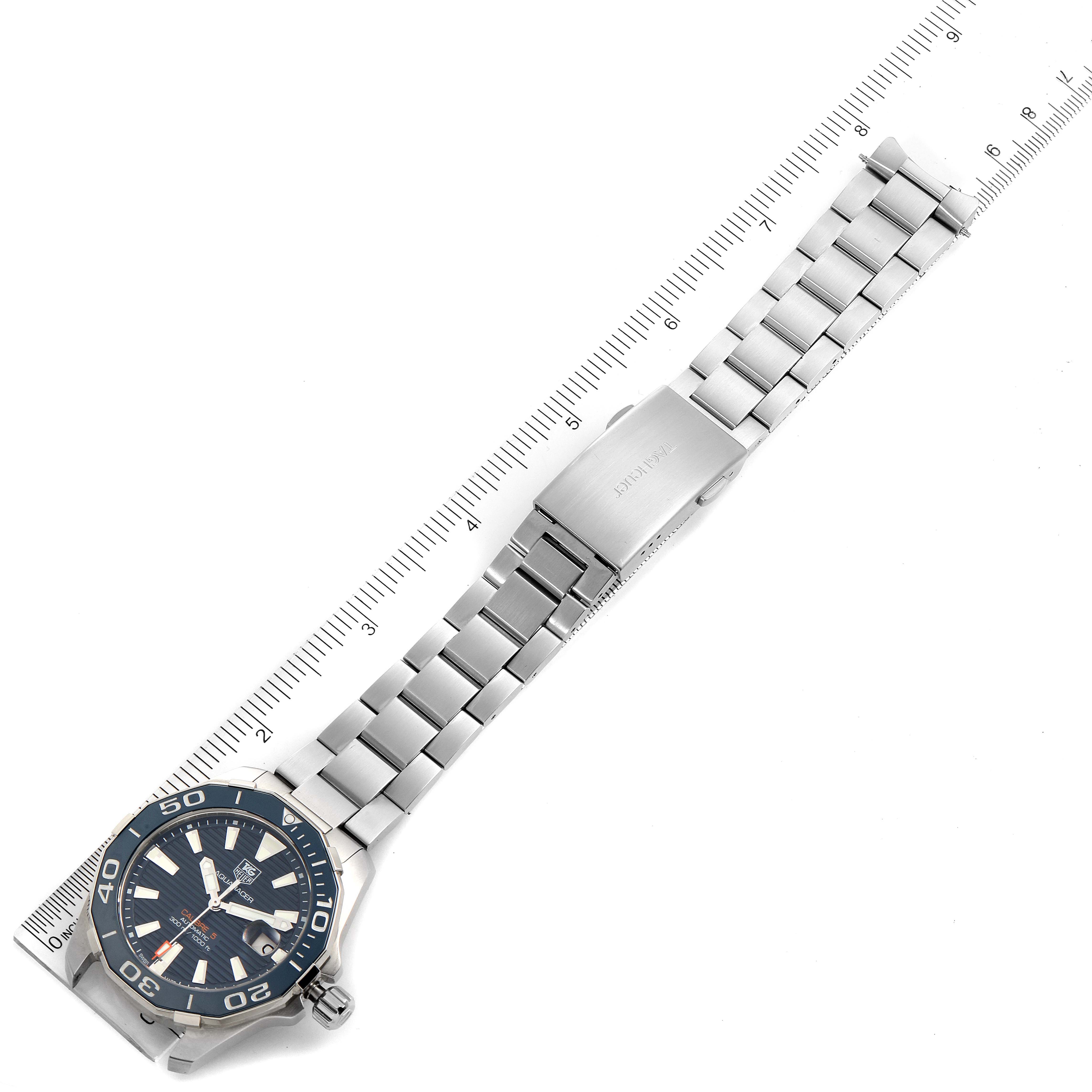 The image shows a Tag Heuer Aquaracer WAY211C.BA0928 Men
s Stainless Steel Blue Dial WAY211C.BA0928 Men
s Stainless Steel Blue Dial watch laying flat with its bracelet extended beside a ruler for measurement.