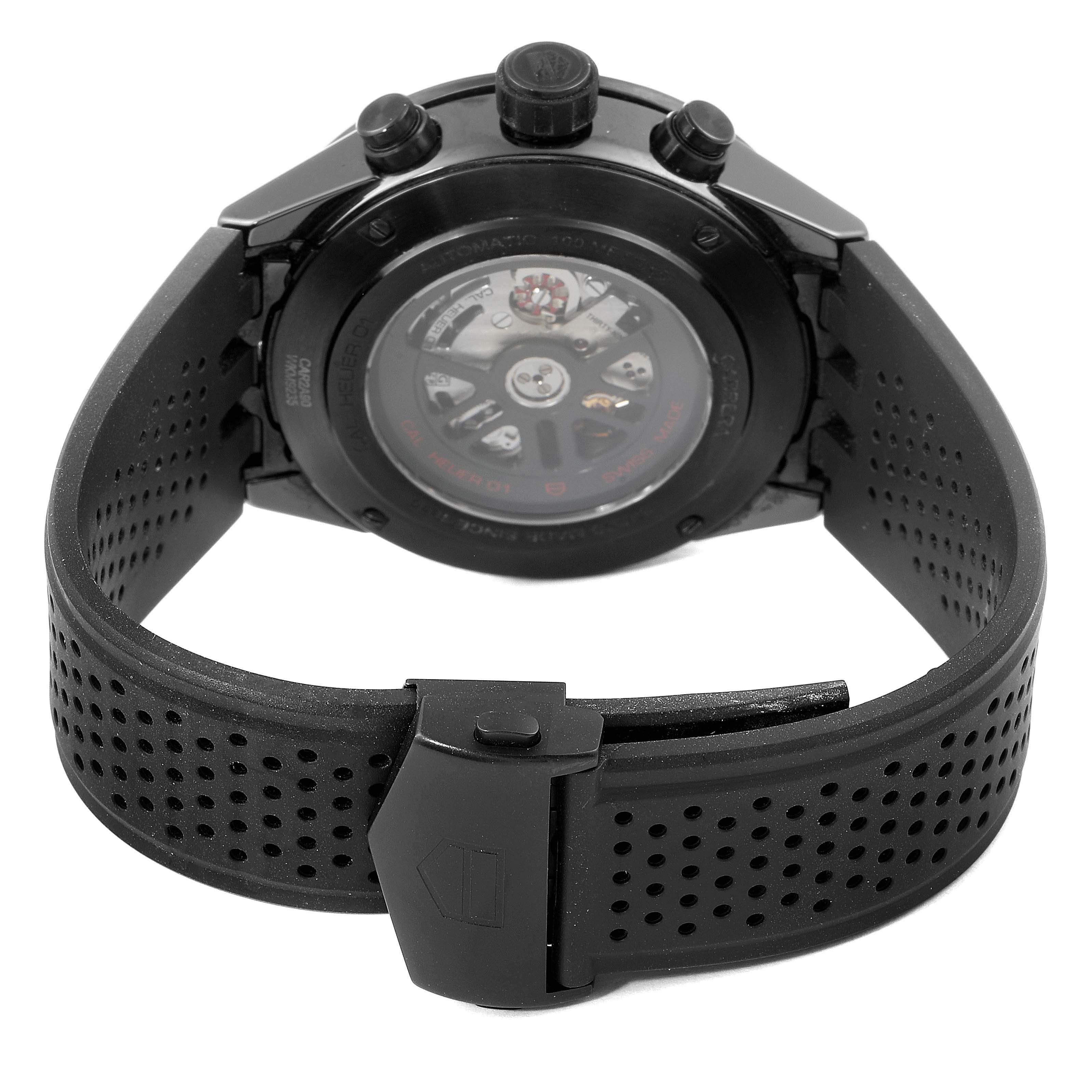 The image shows the back and clasp of a Tag Heuer Carrera CAR2A90.FT6071 Men's Ceramic Black Dial CAR2A90.FT6071 Men's Ceramic Black Dial watch, highlighting its transparent case back and perforated strap.