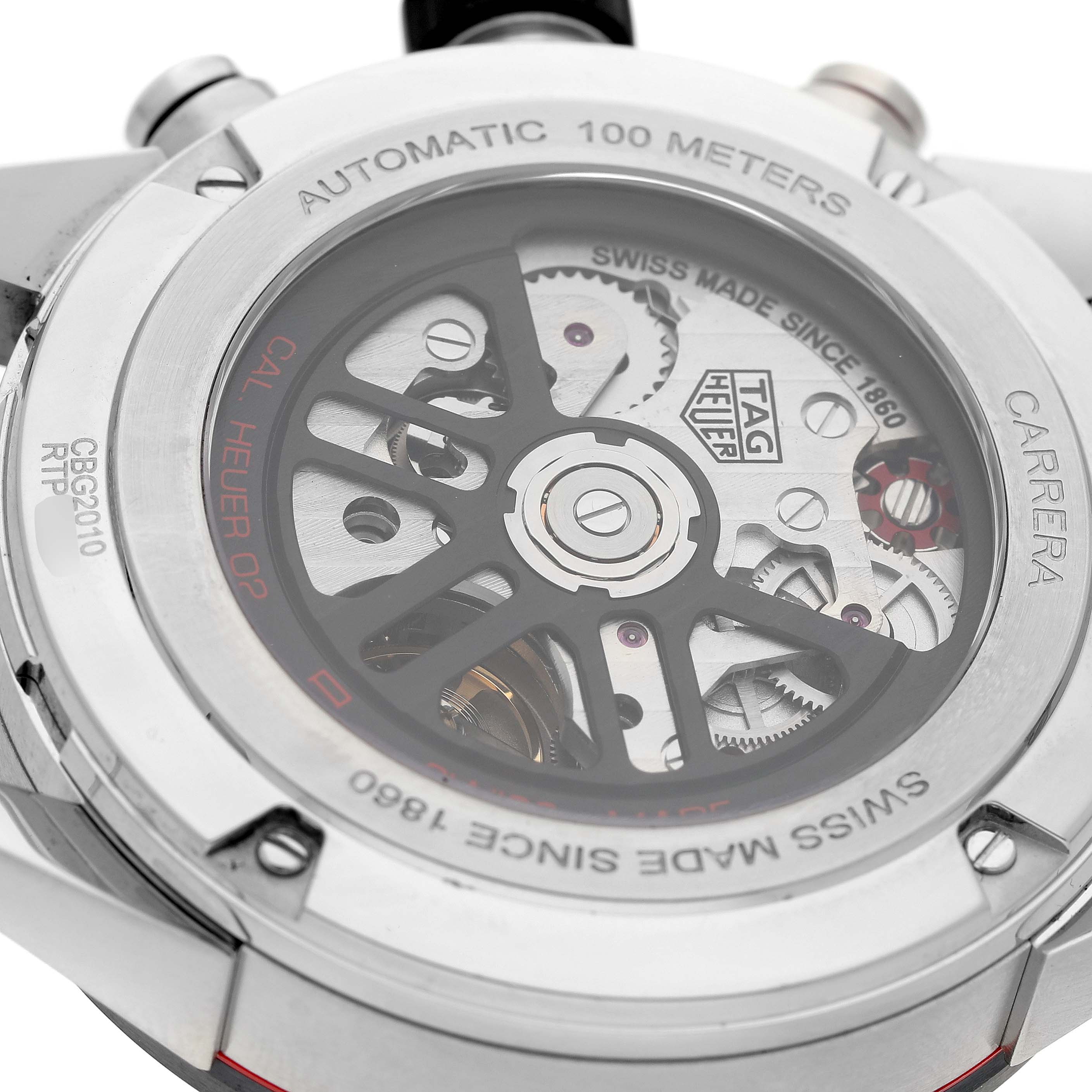 The image shows the back view of a Tag Heuer Carrera CBG2010 Men's Stainless Steel Black Dial watch, highlighting the automatic movement and mechanism details.
