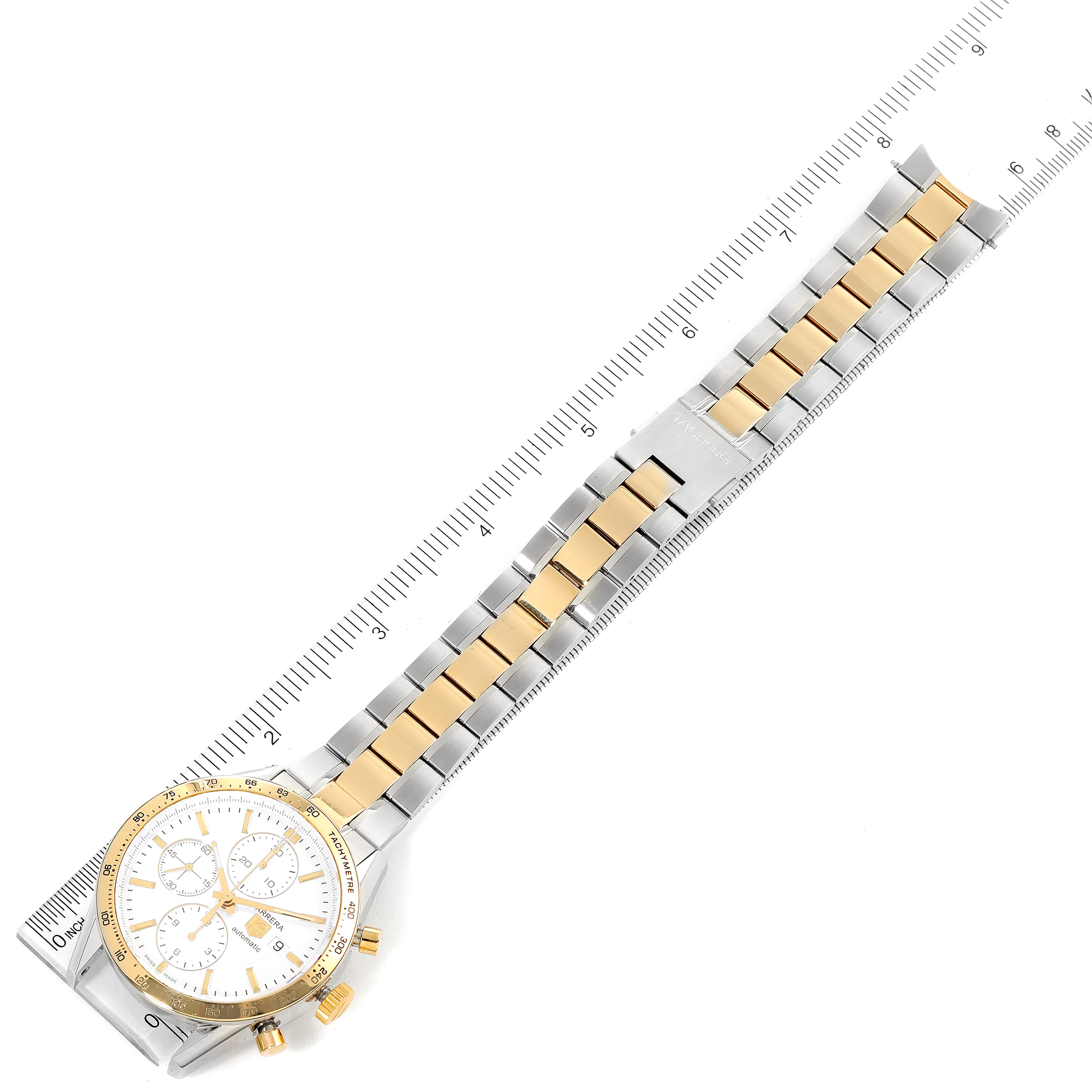 The image shows a Tag Heuer Carrera CV2050.BD0789 Men's Steel and Gold (two tone) Silver Dial CV2050.BD0789 Men's Steel and Gold (two tone) Silver Dial watch from a top-down angle, showcasing the dial, case, and bracelet with a ruler for scale.