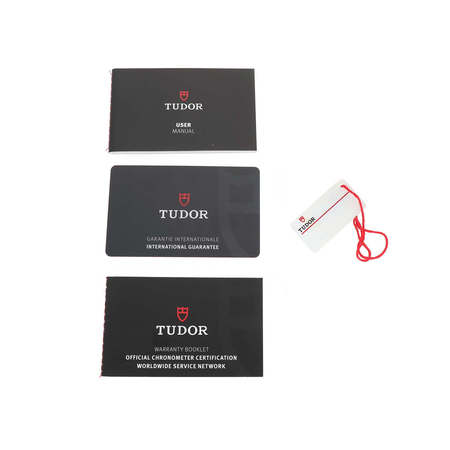 The image shows Tudor Heritage Black Bay 79833MN Men's Steel and Gold (two tone) Black Dial accessories: a user manual, international guarantee, warranty booklet, and a tag.