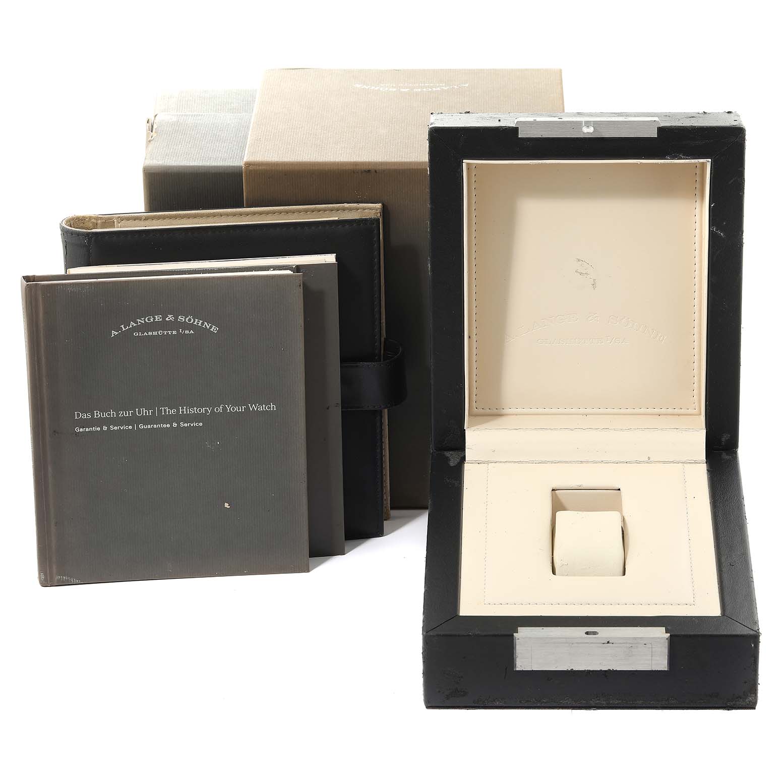 The image shows the packaging and accessories of an A. Lange 
Sohne Saxonia watch, including the watch box, manuals, and outer box.