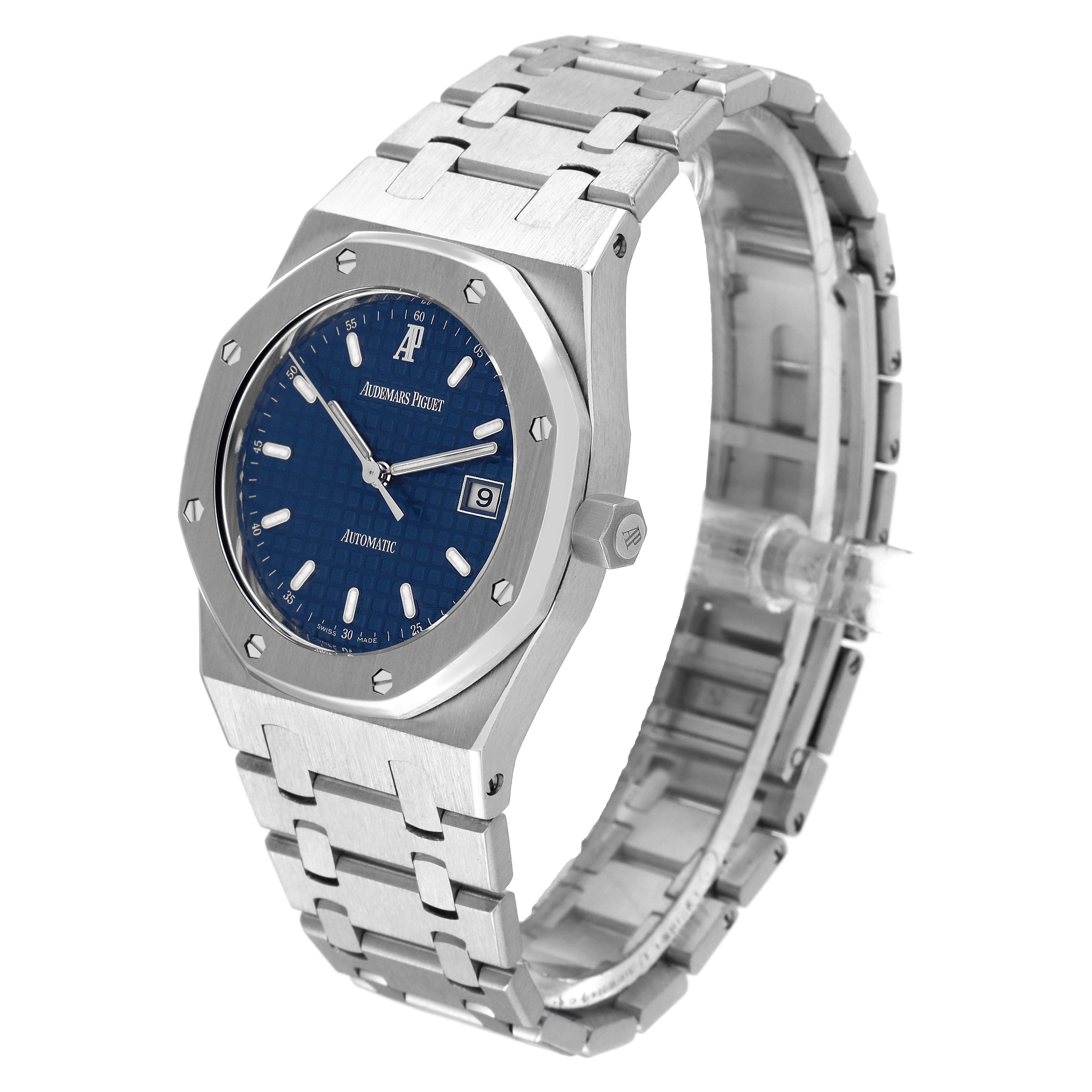 The image shows a side angle of an Audemars Piguet Royal Oak 15000ST.OO.0789ST.01 Men's Stainless Steel Blue Dial 15000ST.OO.0789ST.01 Men's Stainless Steel Blue Dial watch, featuring its case, blue dial, date display, and metal bracelet.