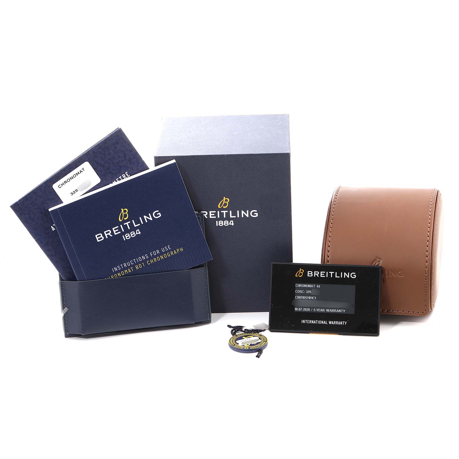 The image shows accessories and documents for the Breitling Chronomat CB0110121B1C1 Men's Steel and Gold (two tone) Black Dial CB0110121B1C1 Men's Steel and Gold (two tone) Black Dial watch, including manuals, a warranty card, and a leather case.