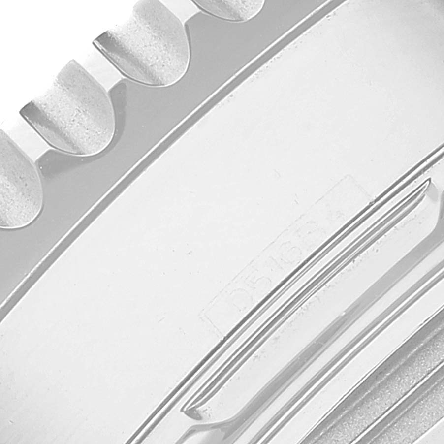 This close-up image shows a portion of the bezel or edge of a Breitling Navitimer AB0121 Men's Stainless Steel Grey Dial AB0121 Men's Stainless Steel Grey Dial watch, highlighting its ridged outer edge details.