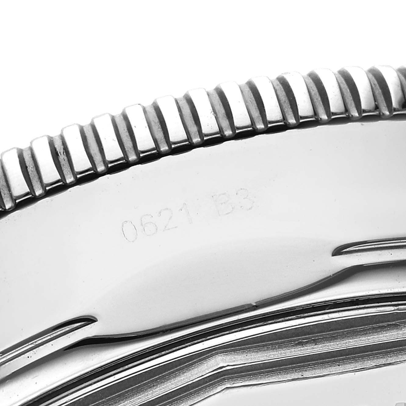 The image shows a close-up of the ridged bezel and part of the case back of the Breitling Superocean AB2010 Men's Stainless Steel Black Dial AB2010 Men's Stainless Steel Black Dial watch.