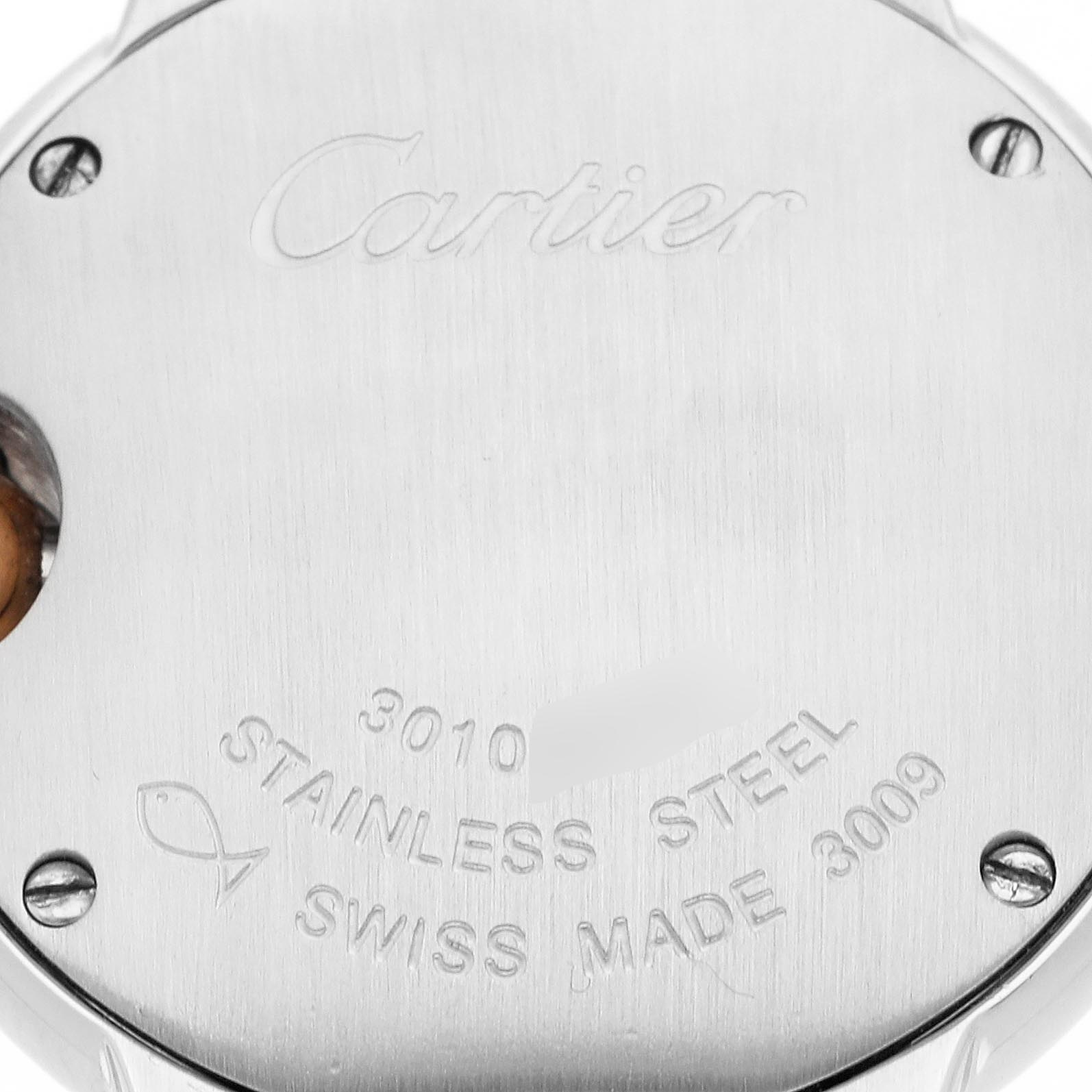 The image shows the back case of a Cartier Ballon Bleu WE902030 Women
s Steel and Gold (two tone) Silver Dial WE902030 Women
s Steel and Gold (two tone) Silver Dial watch, highlighting the brand name and specifications like "STAINLESS STEEL" and "SWISS MADE."
