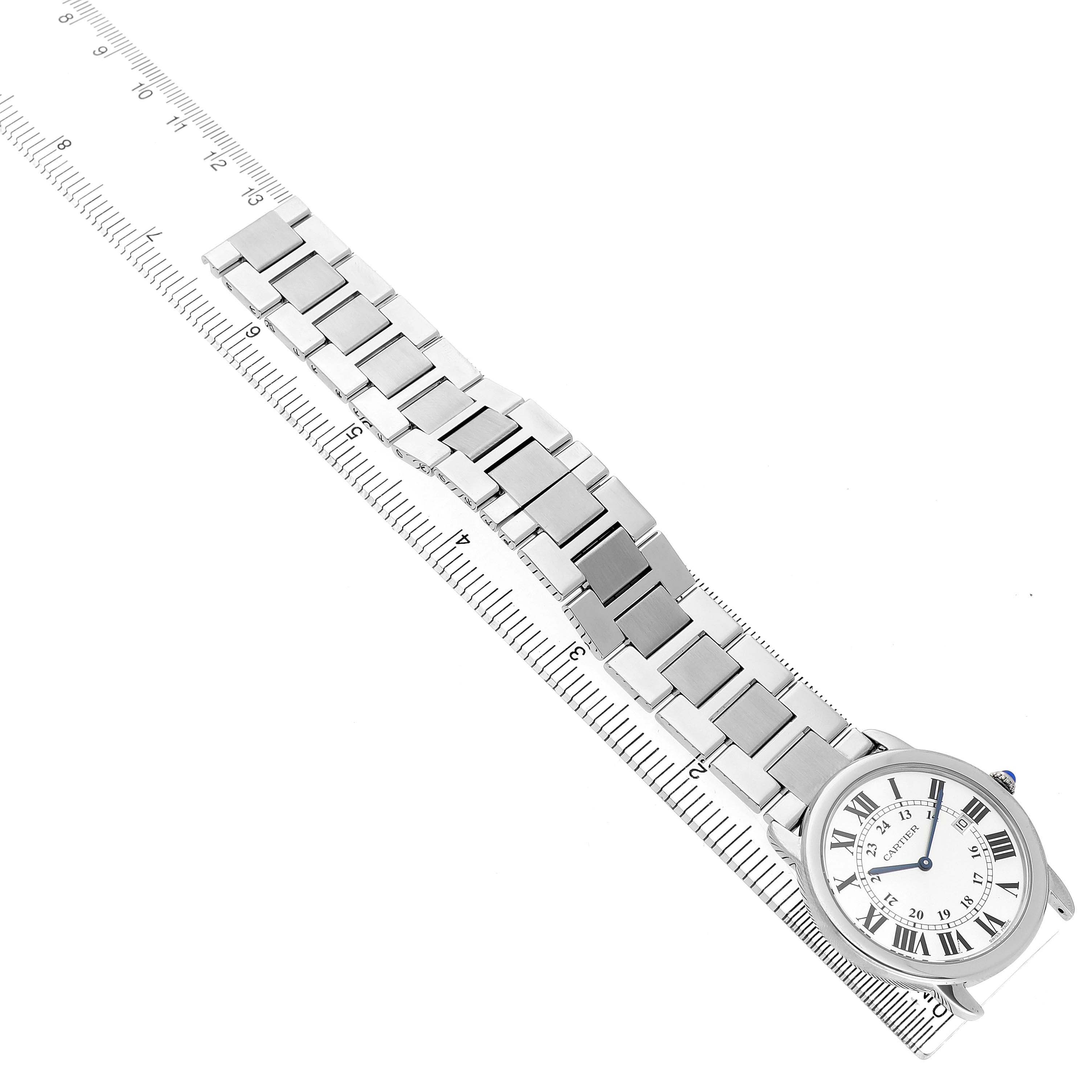 The image shows the Cartier Ronde W6701005 Men's Stainless Steel Silver Dial watch from a high-angle view, displaying the face and metal strap aligned with a ruler.