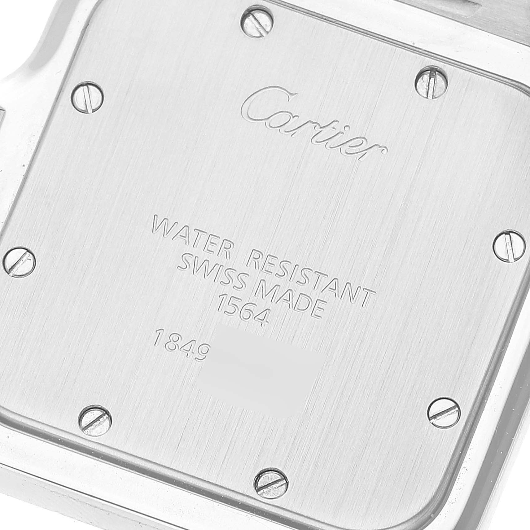 This is the back case of a Santos model by Cartier, showing its screws and engraved details.